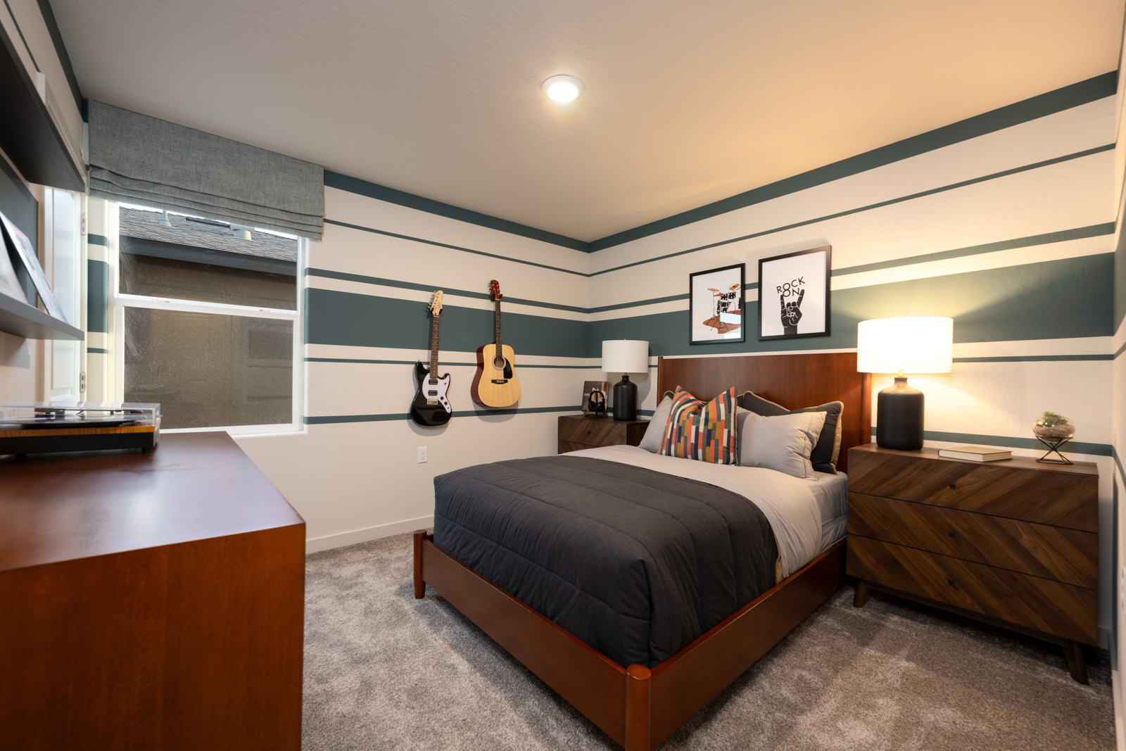 A bedroom with a bed and guitars.