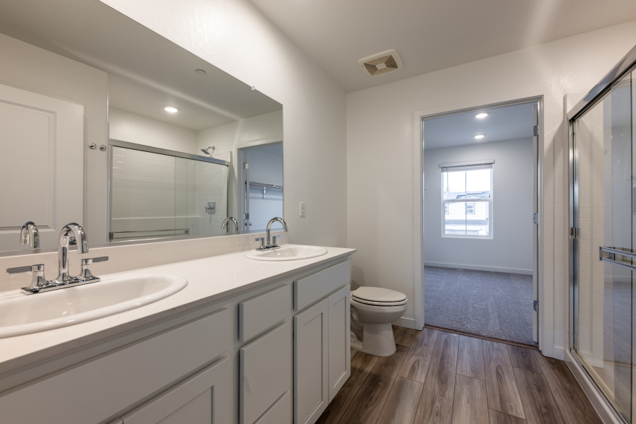 A bathroom with a toilet sink and mirror.