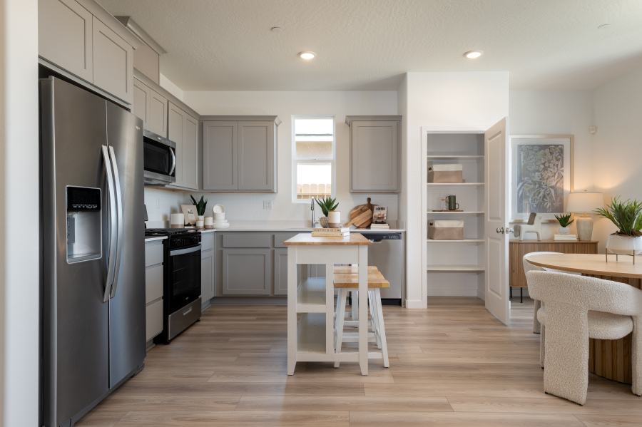 A kitchen with a table and stool.