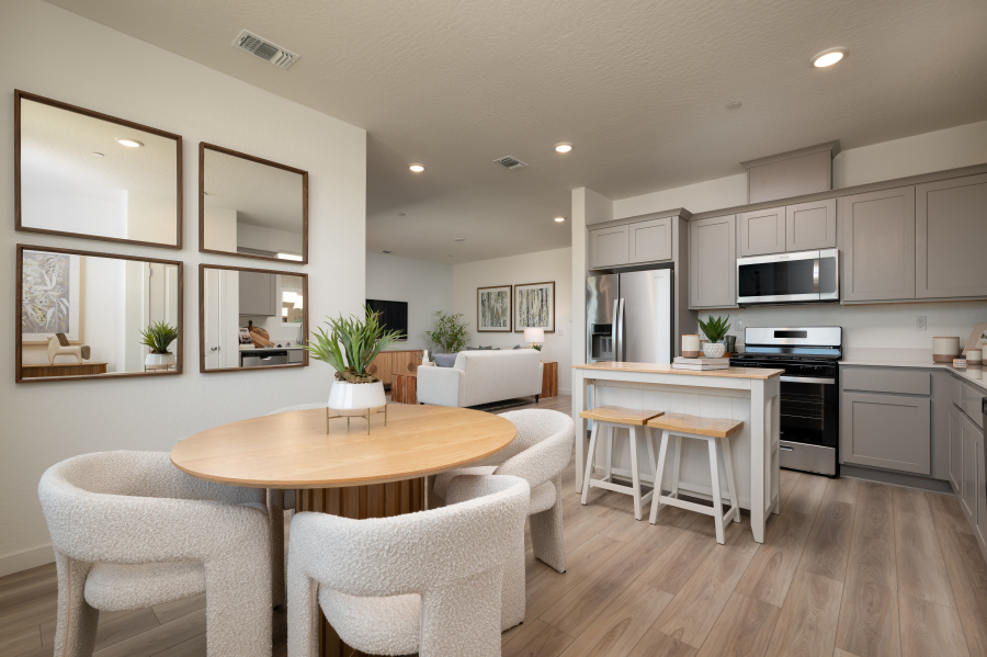 A kitchen with a table and chairs.