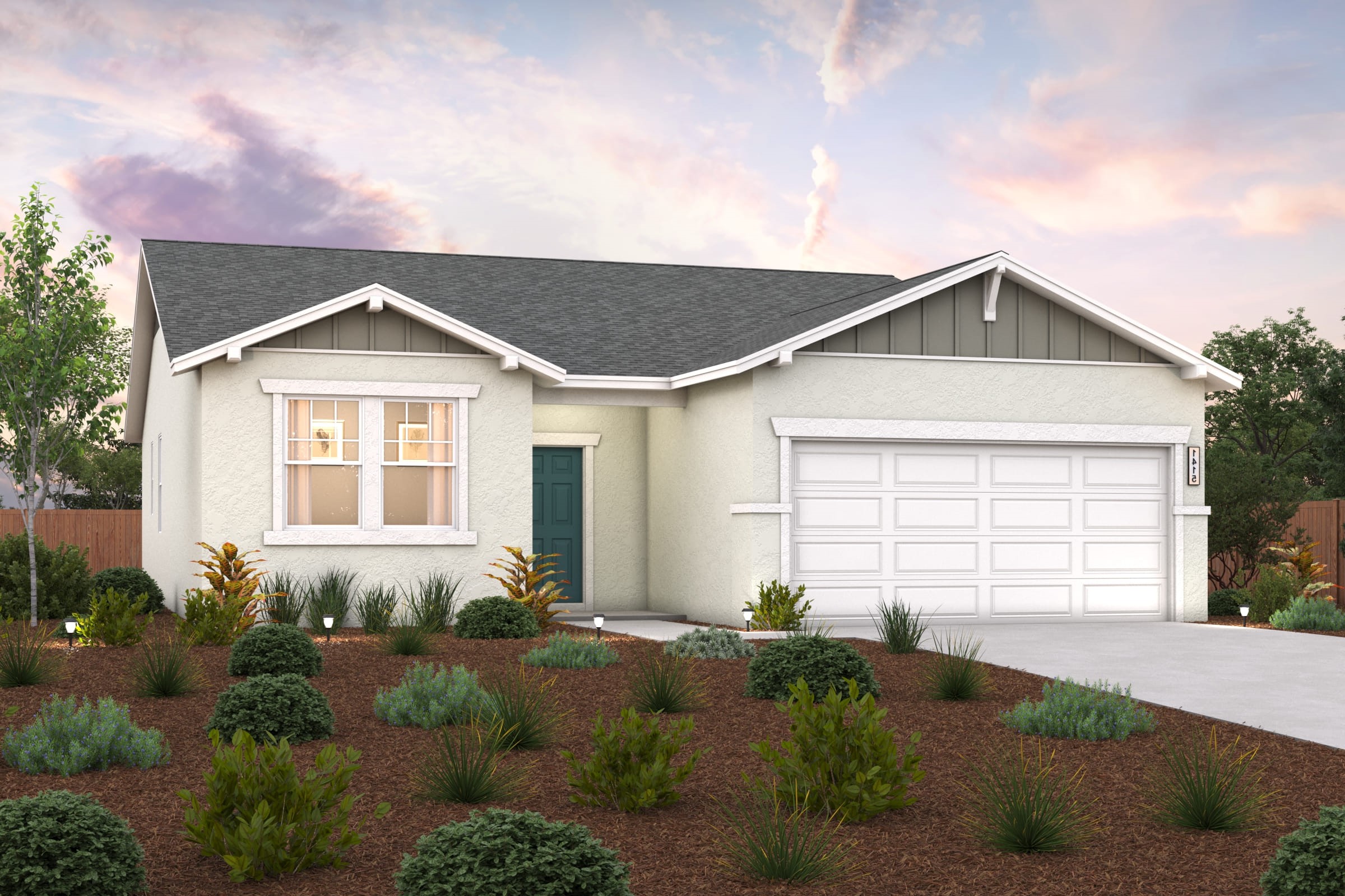 A house with a garage and bushes in front of it.