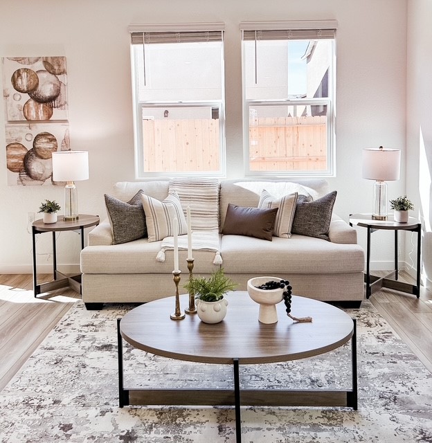 A white couch with pillows.