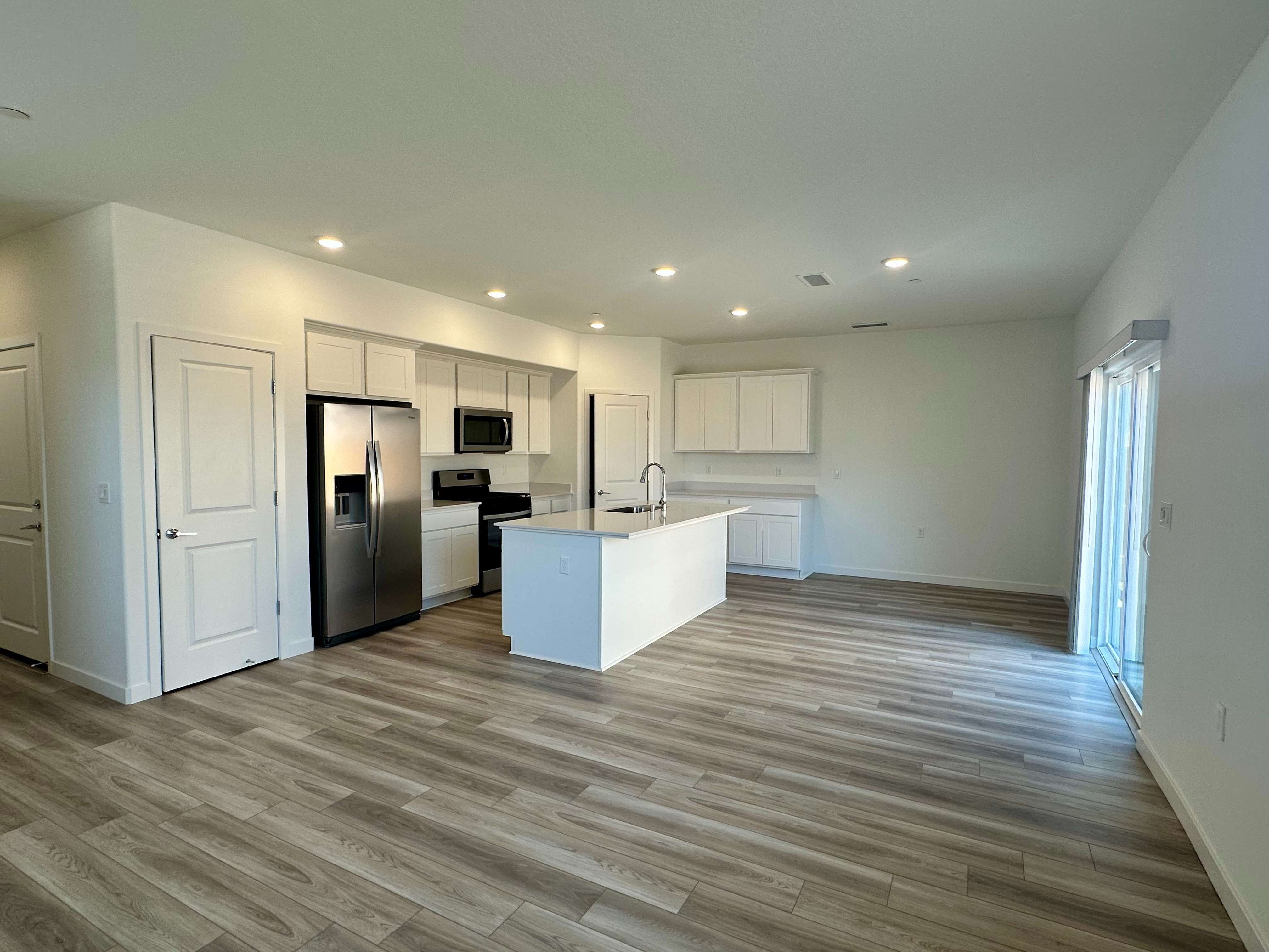 A kitchen with white cabinets.