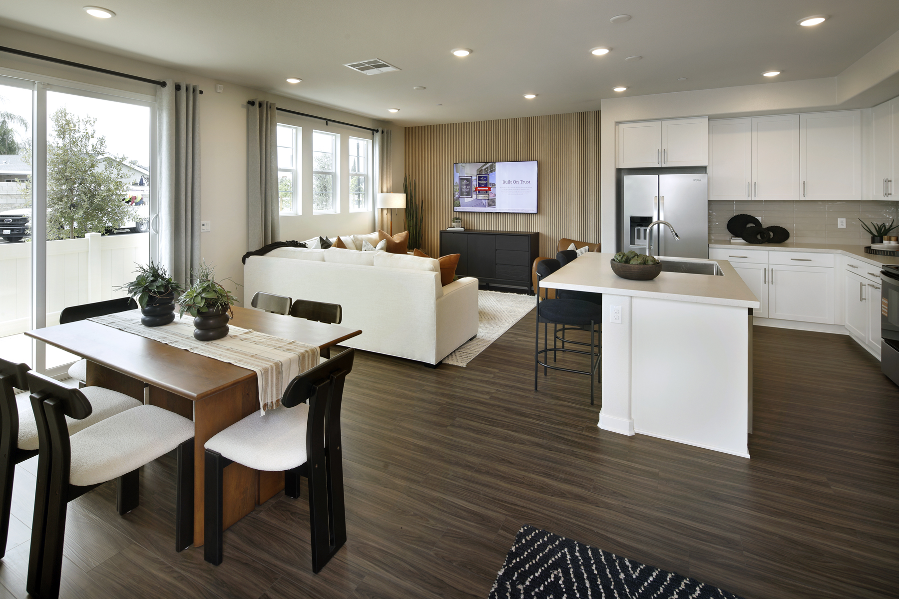 A large kitchen with a large white couch and a table.