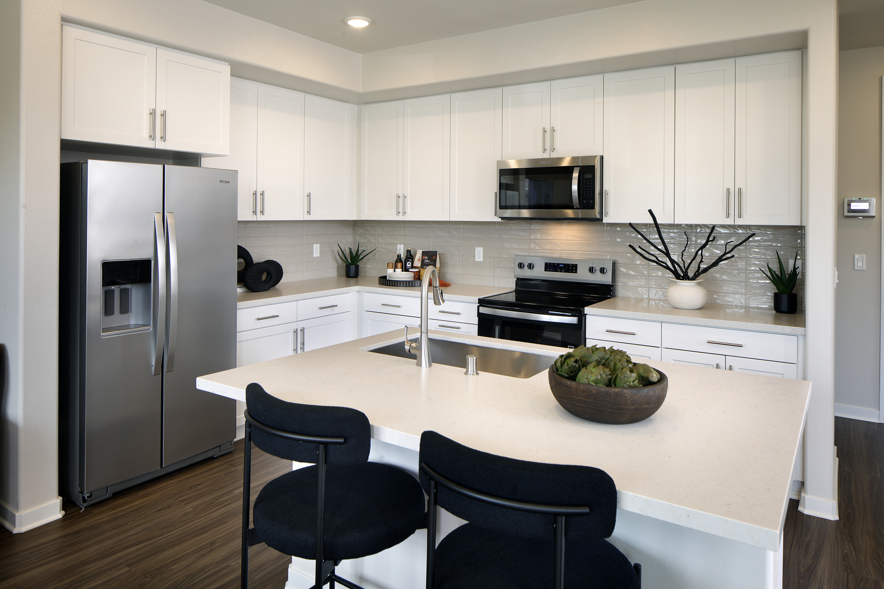 A kitchen with white cabinets.