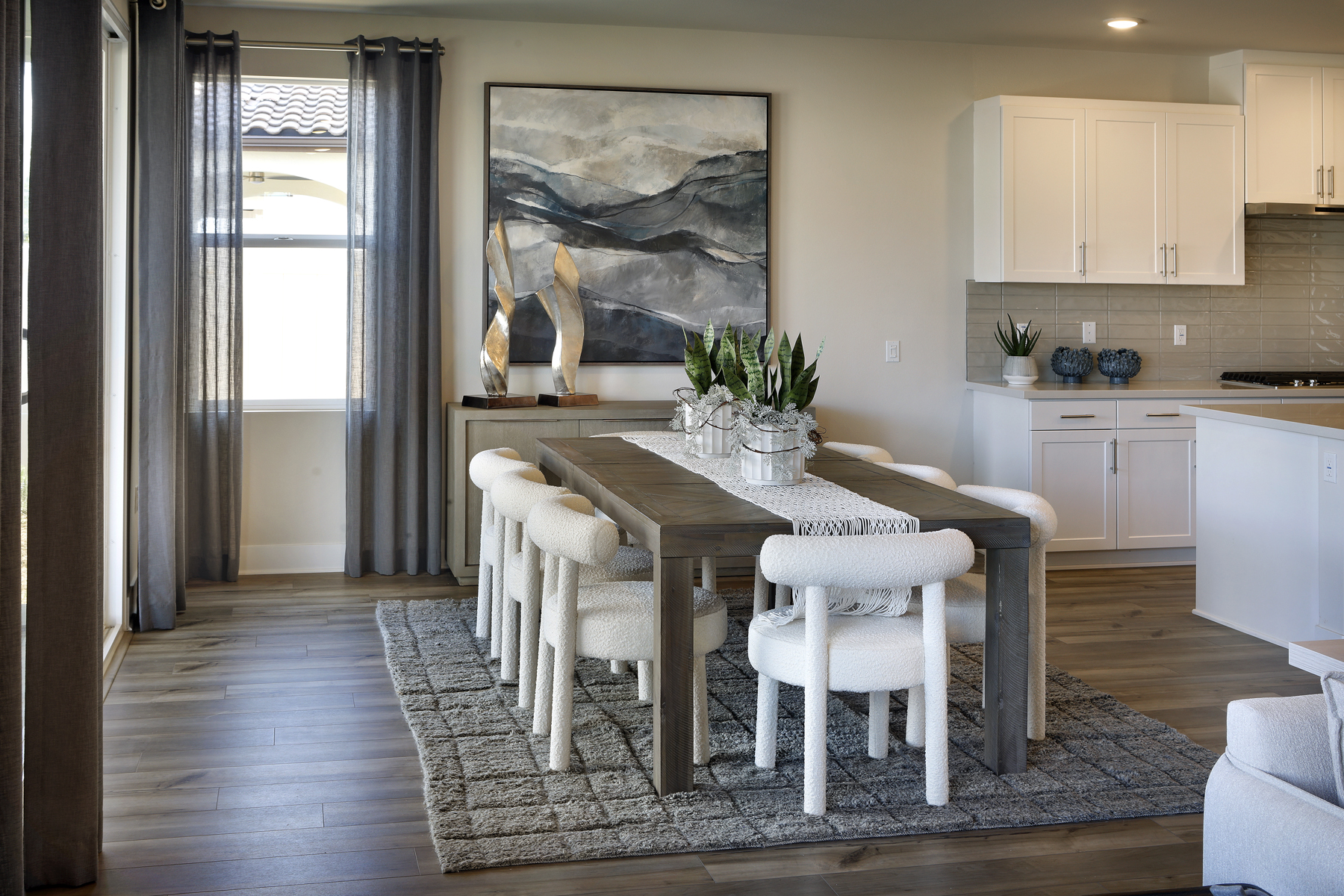 A kitchen with a dining table and chairs.