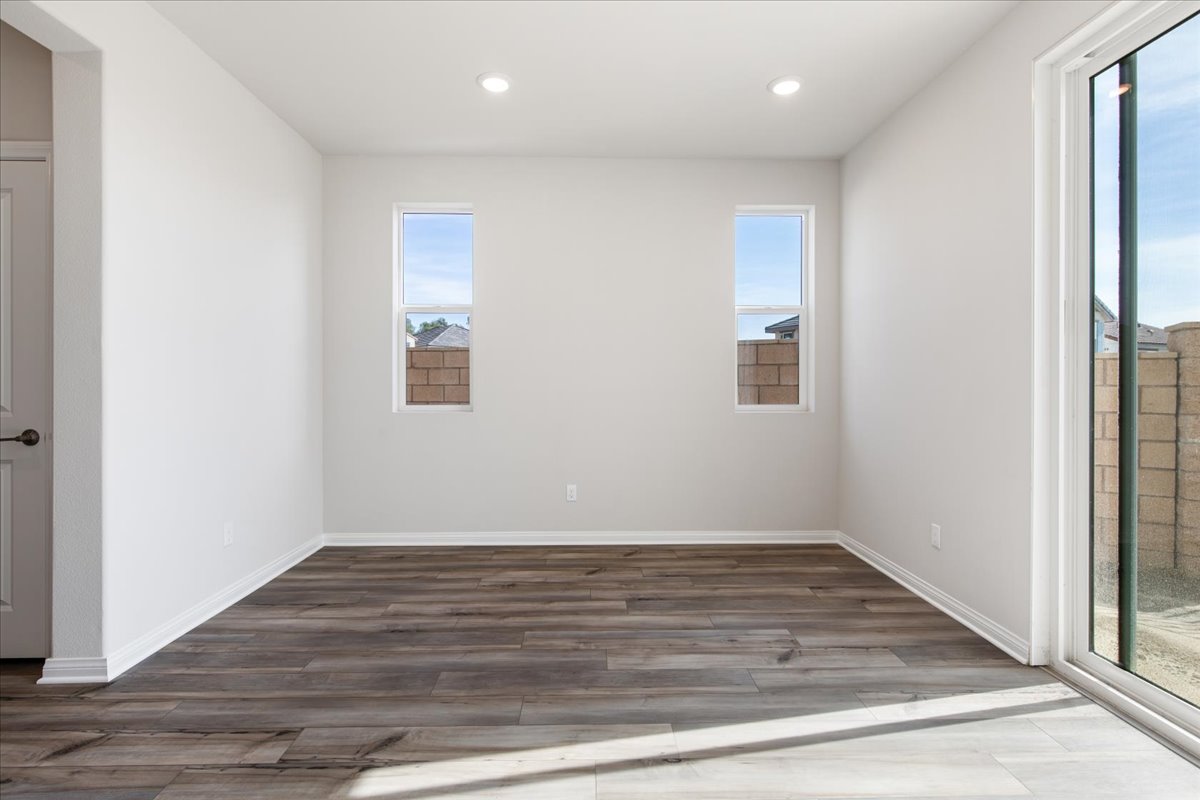 A room with a wood floor and windows.