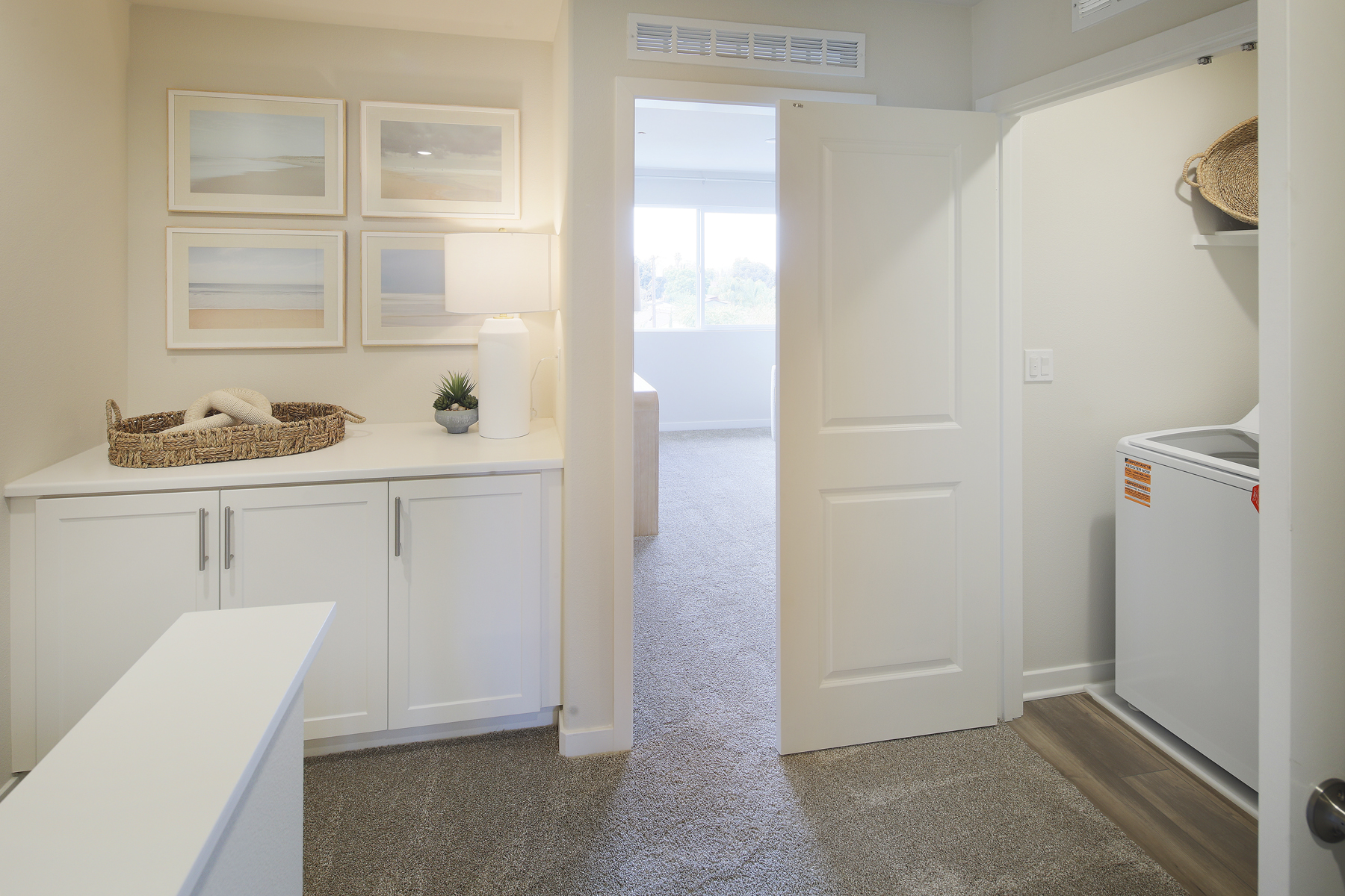 A kitchen with white cabinets.