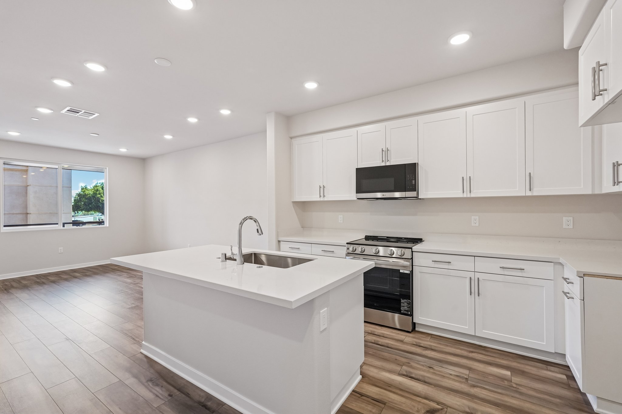 A kitchen with white cabinets.