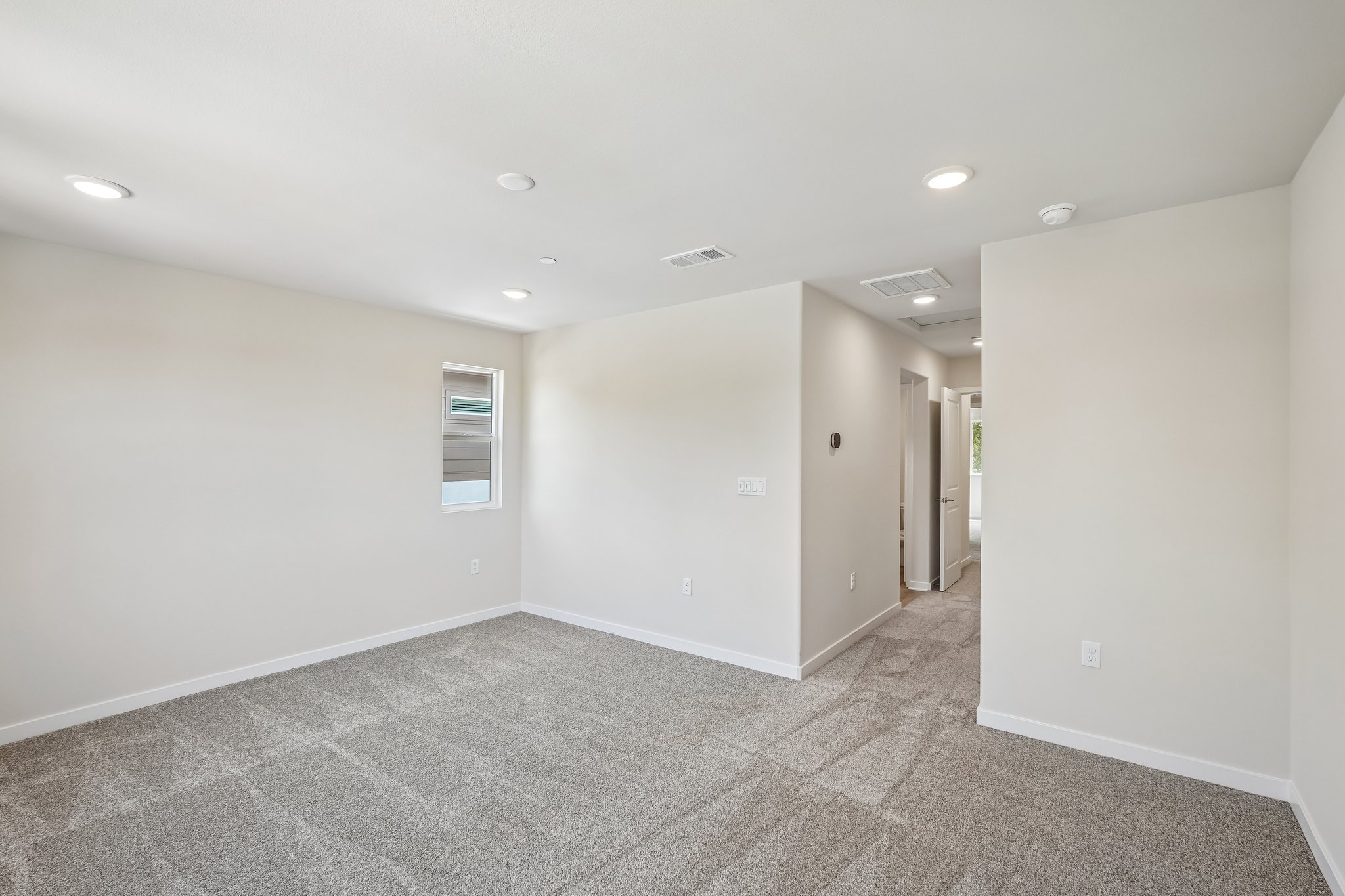 A hallway with white walls.