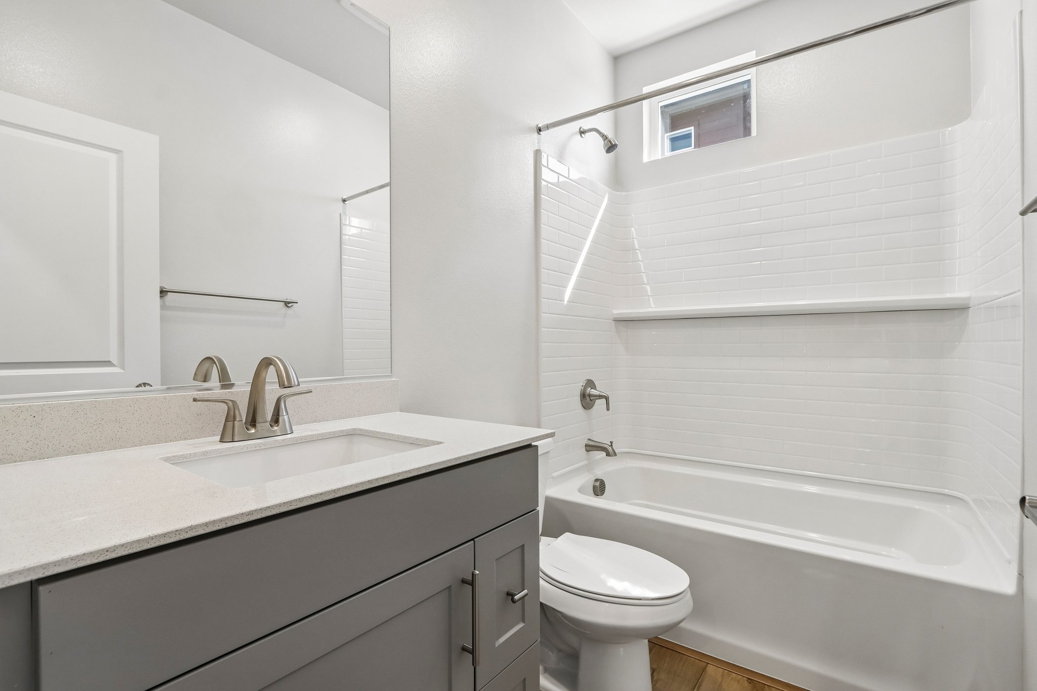 A bathroom with a tub sink and toilet.