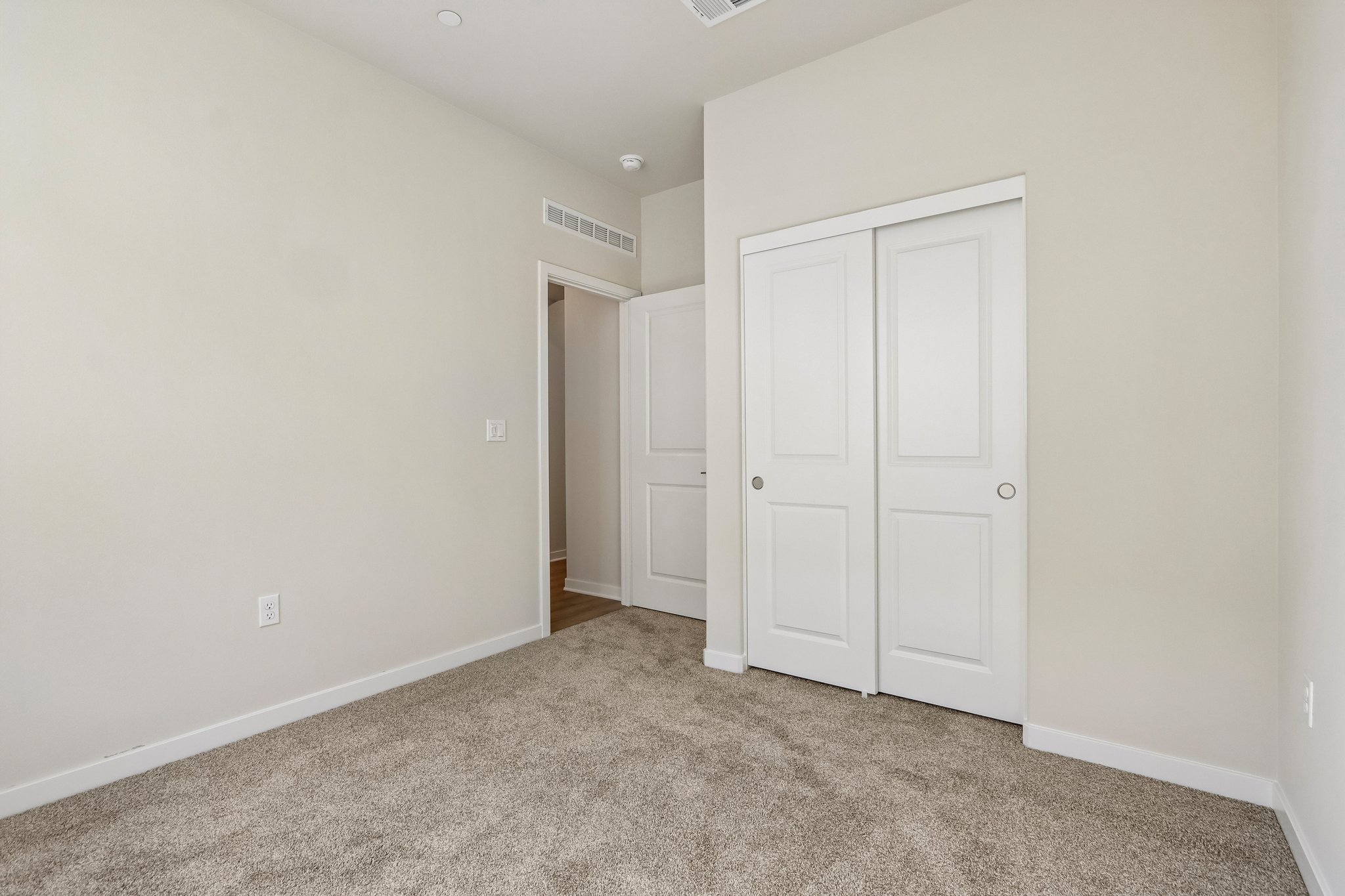 A hallway with white doors.