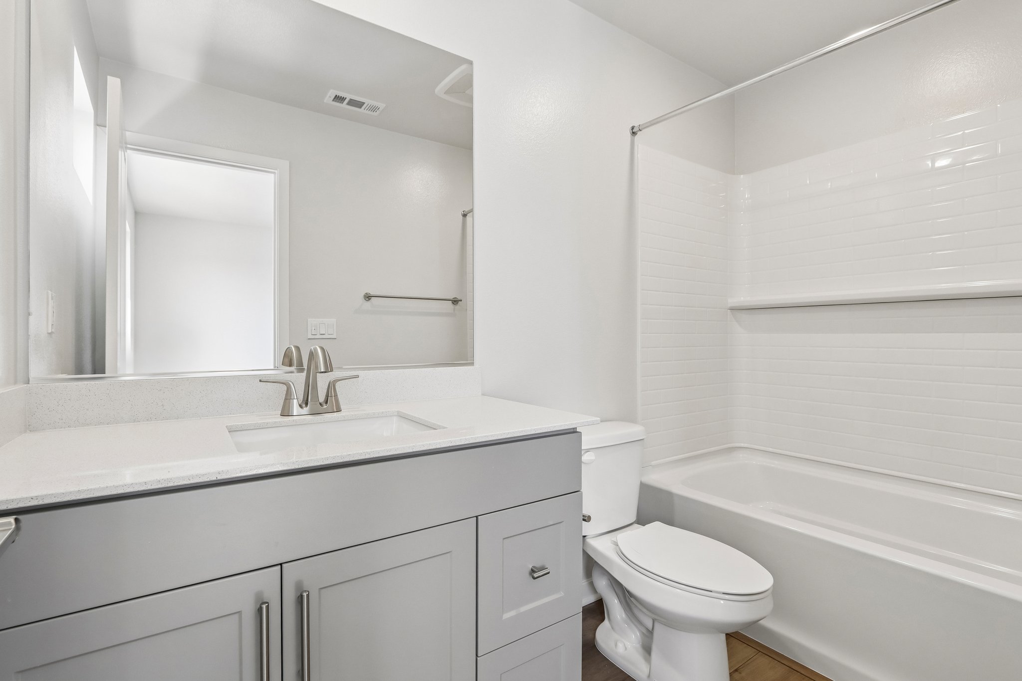 A bathroom with a tub sink and toilet.