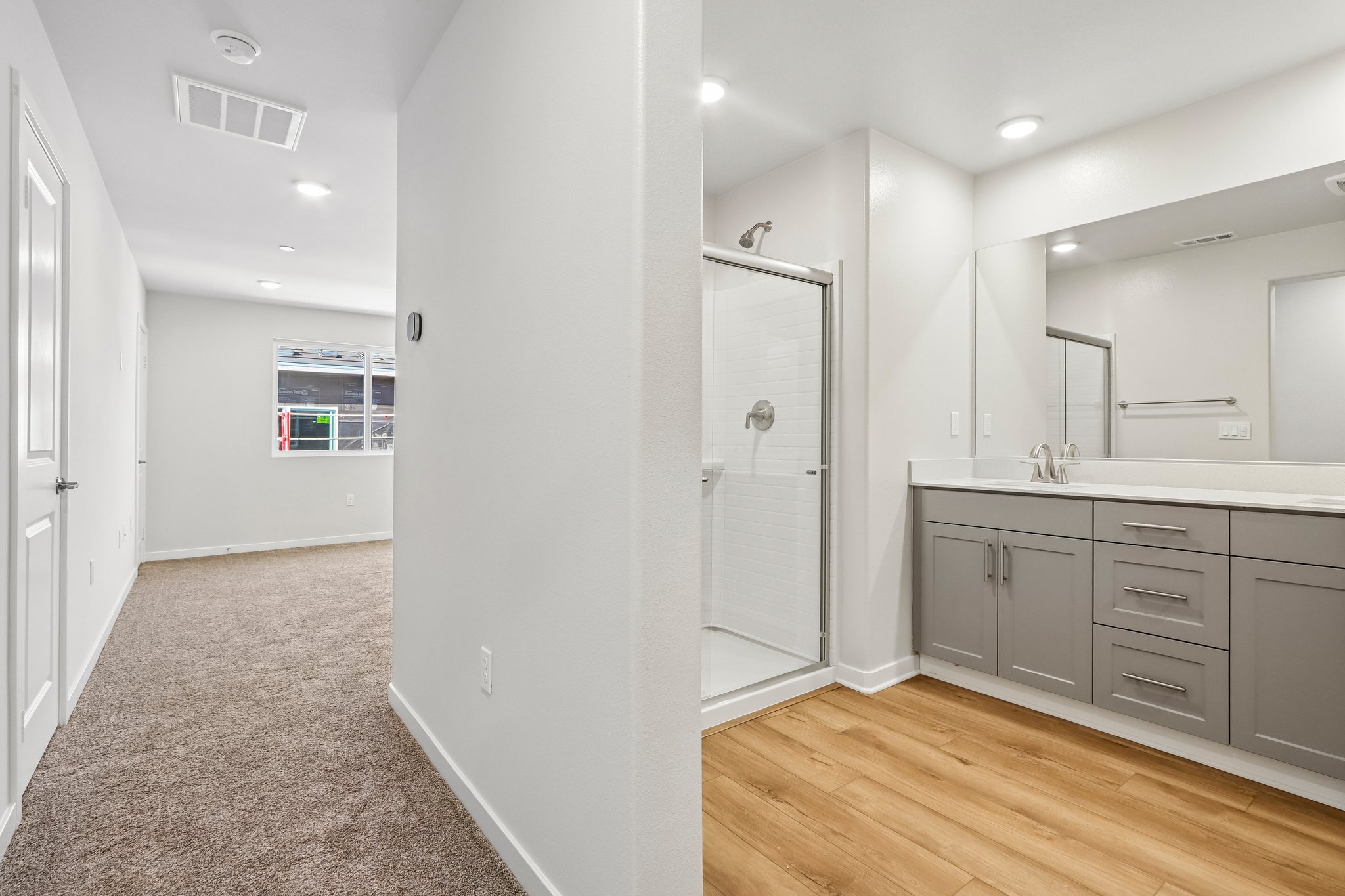 A bathroom with white cabinets.