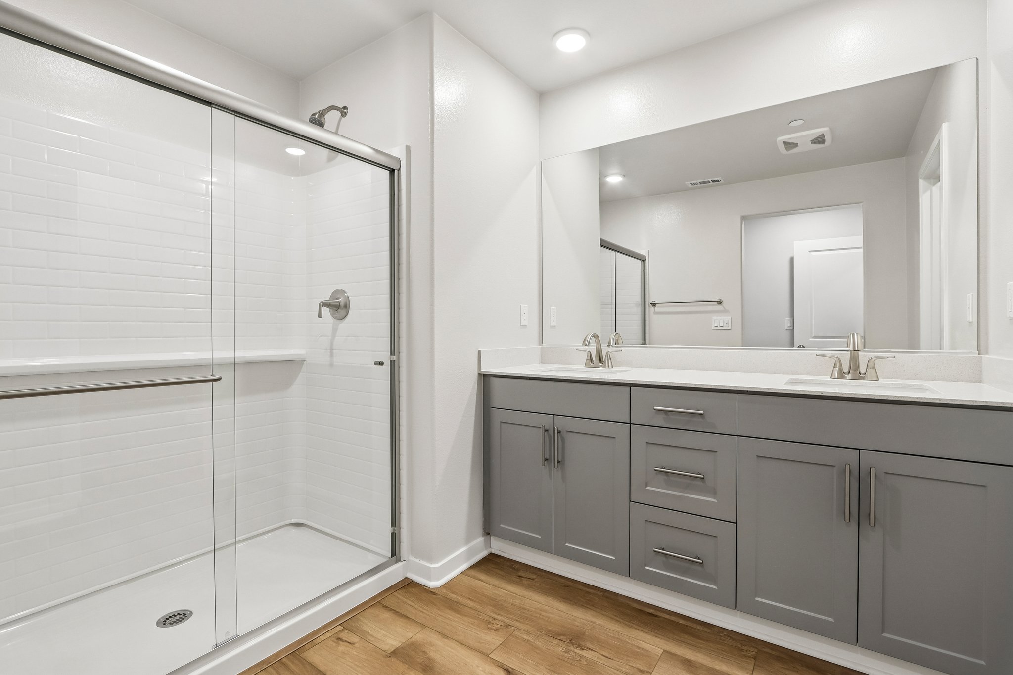 A bathroom with a shower and sink.