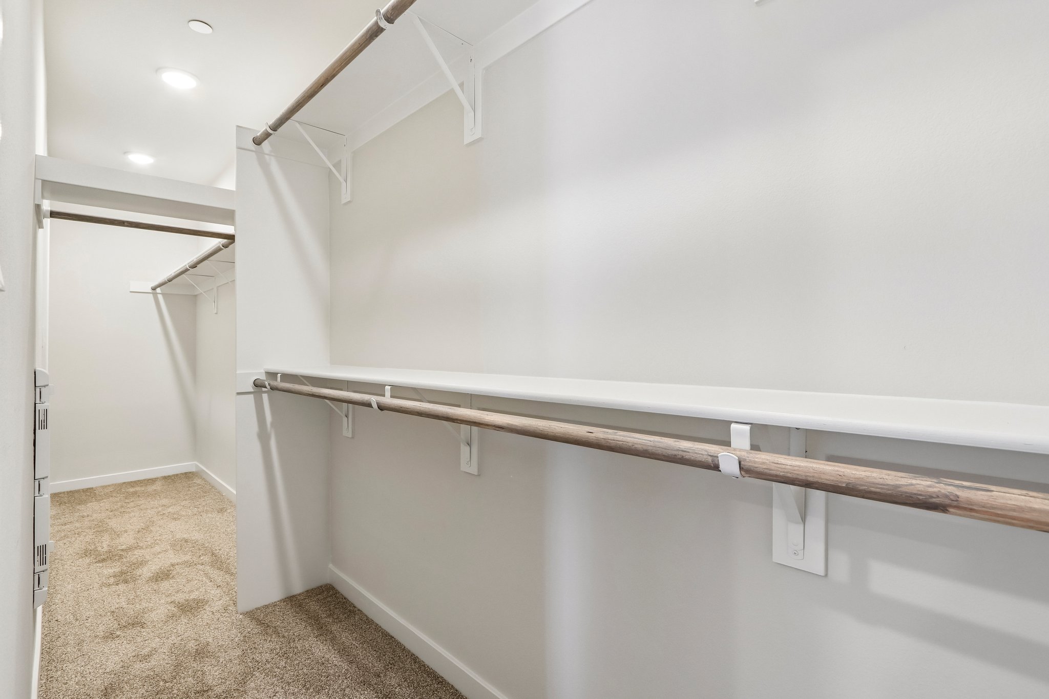 A white room with a metal railing.