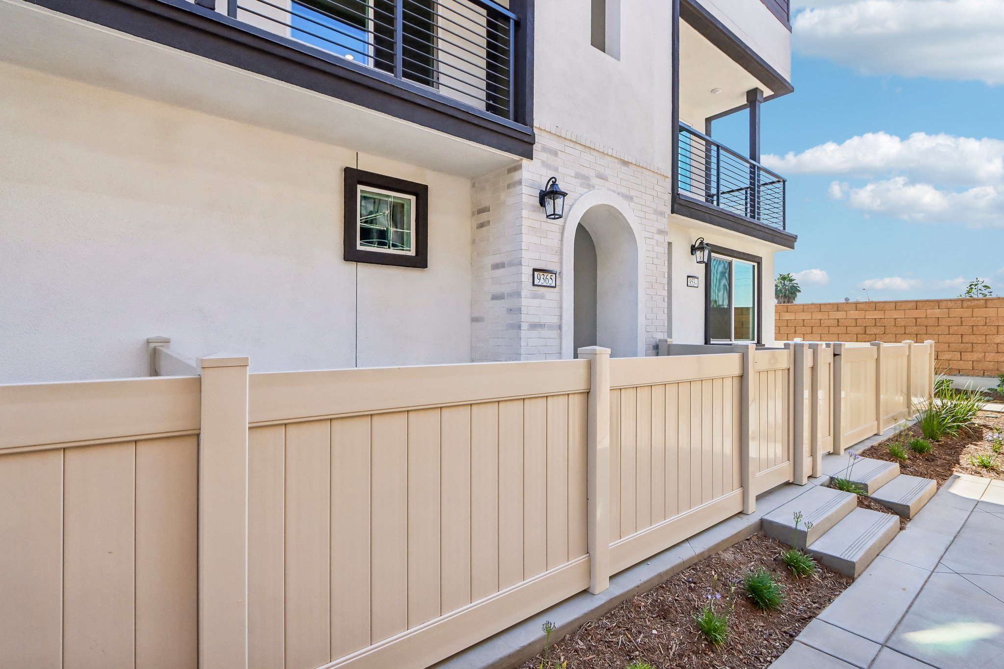 A white building with a fence.