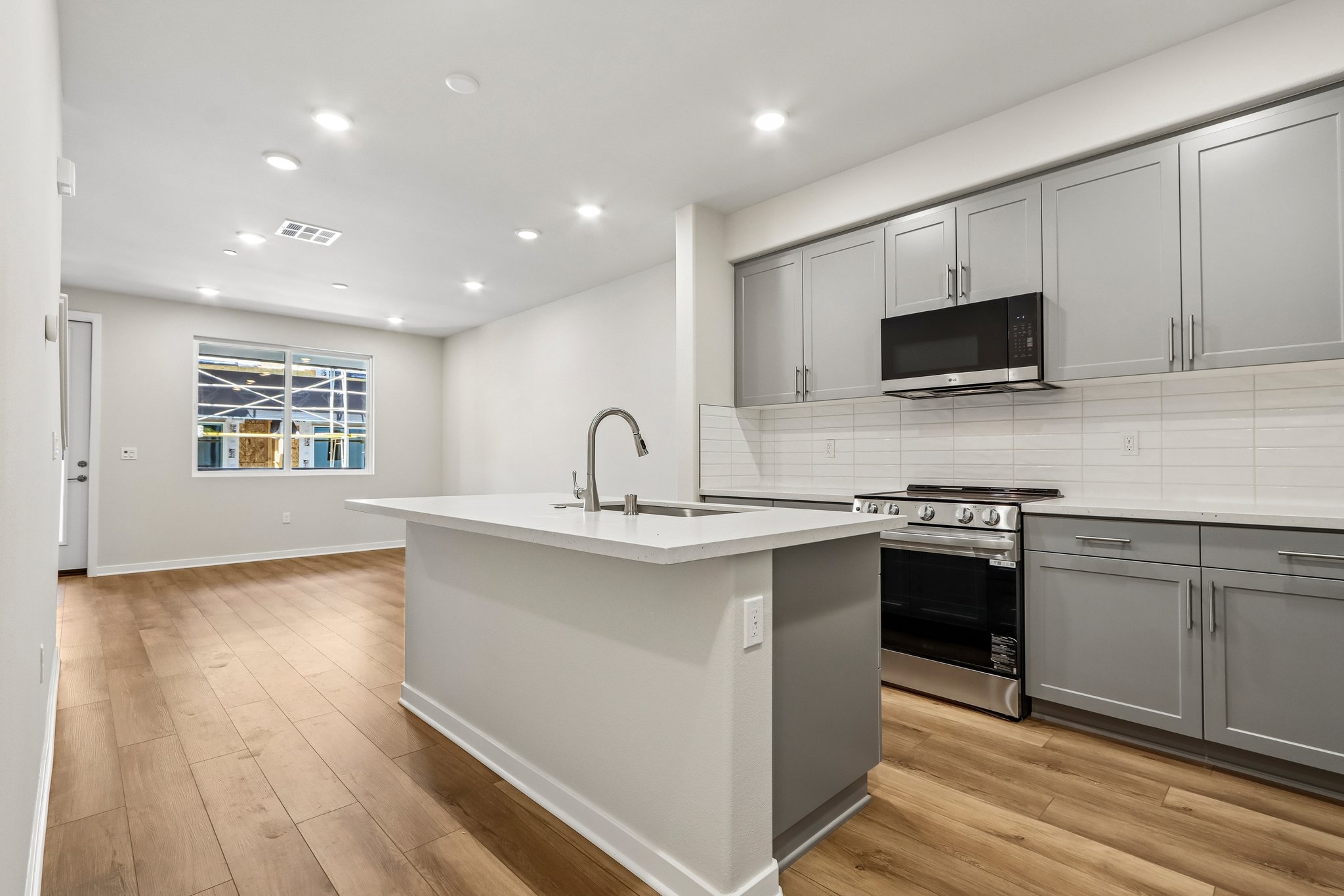 A kitchen with white cabinets.