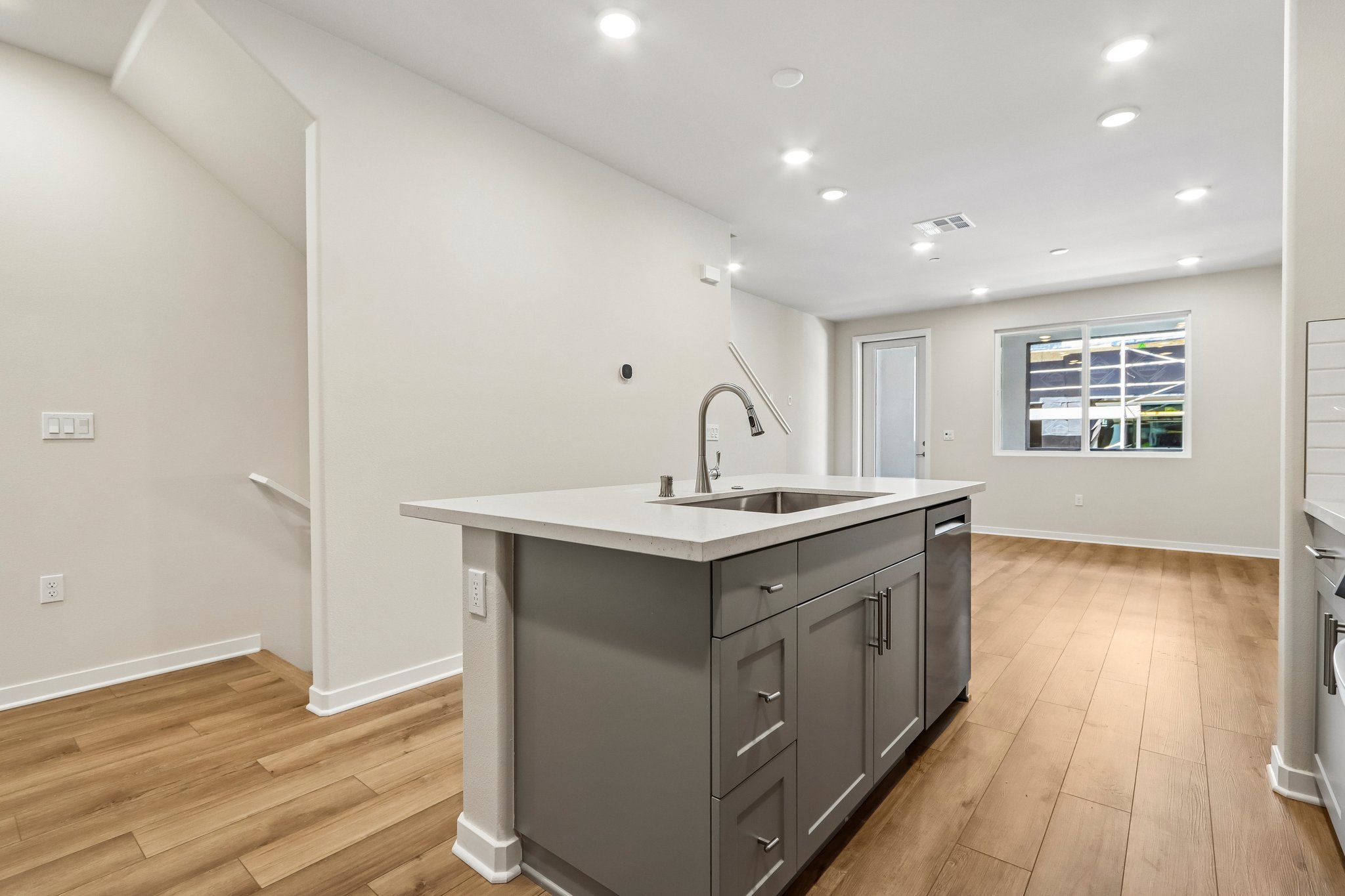 A kitchen with a sink and cabinets.