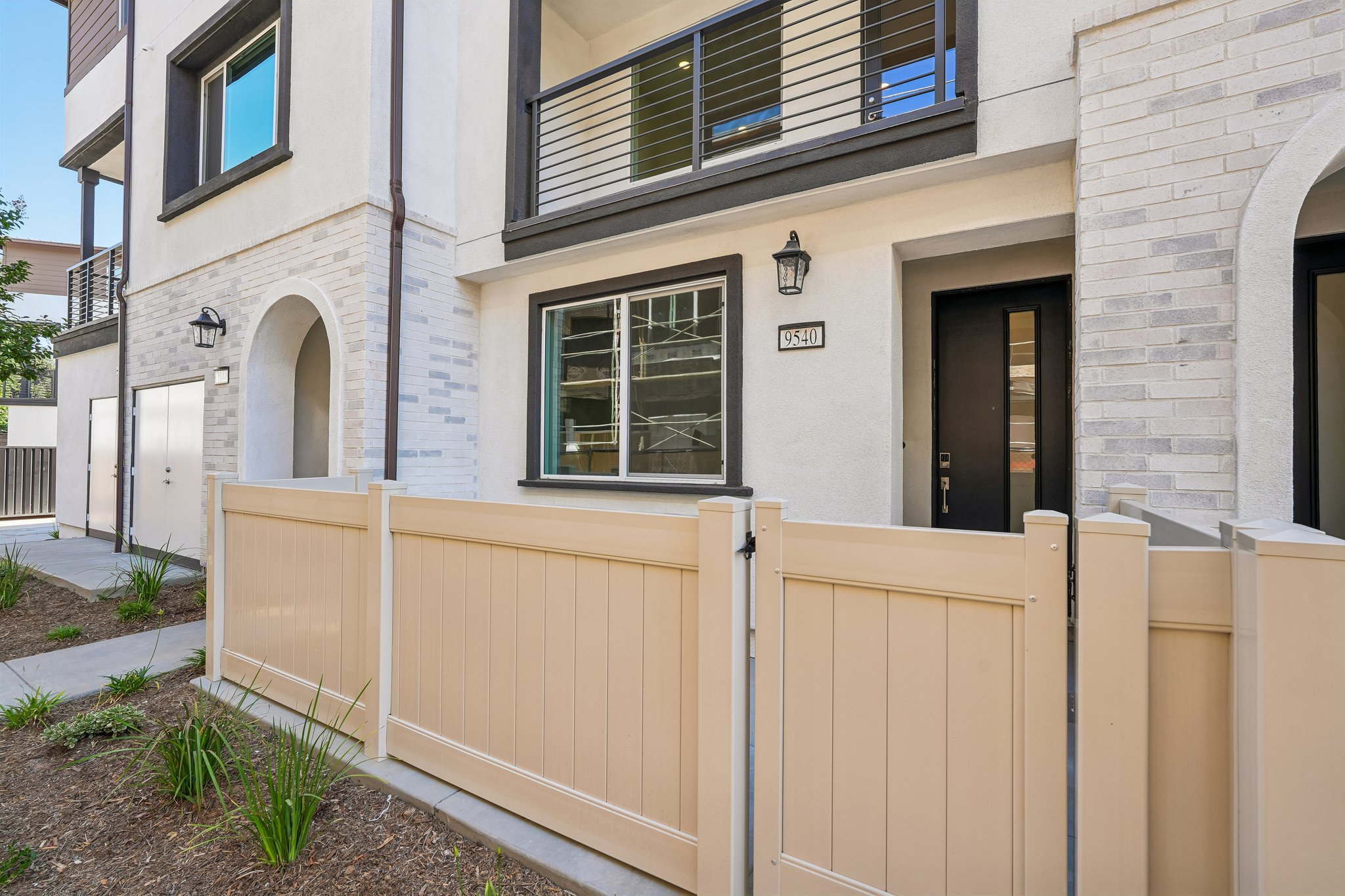 A white building with a fence.