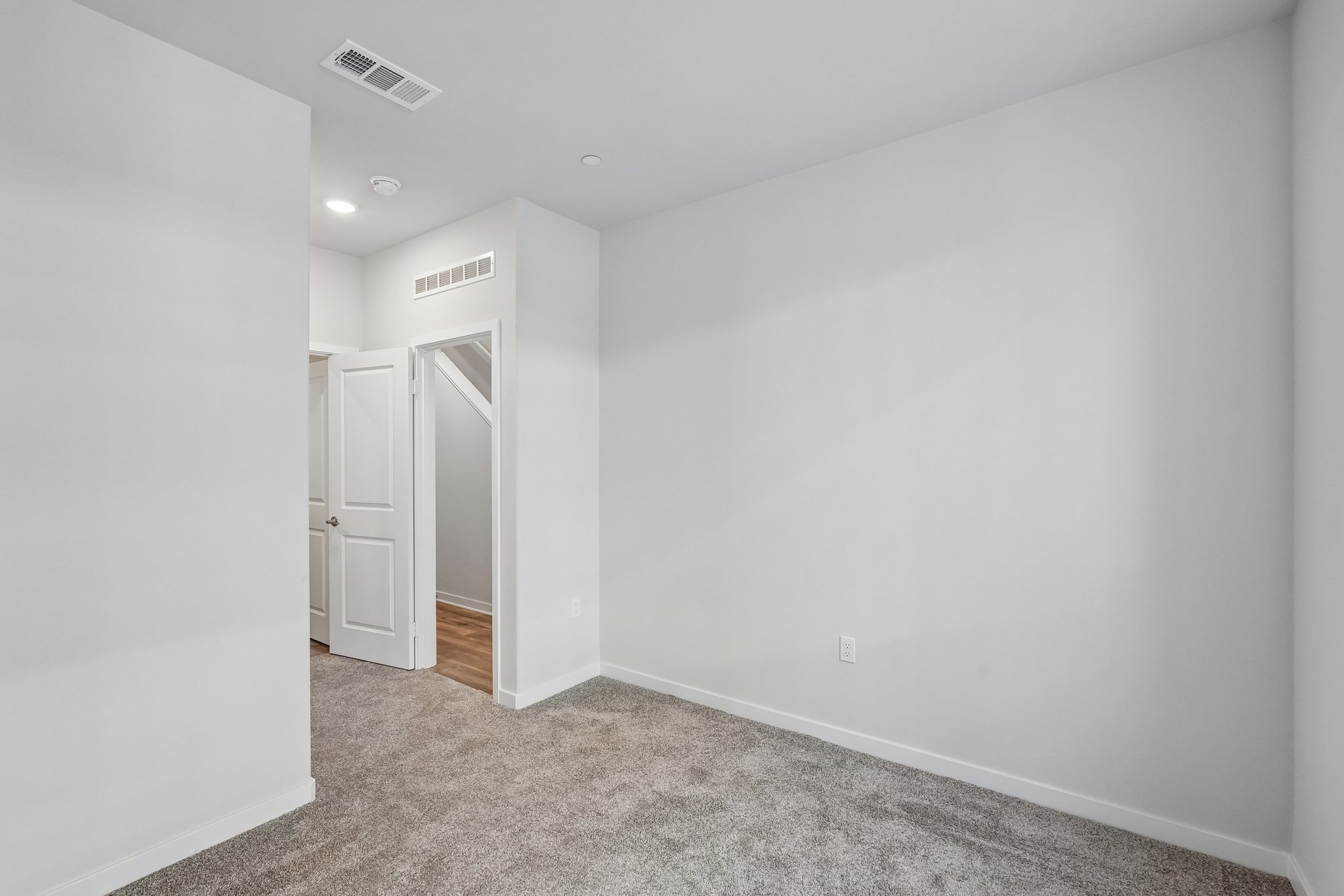 A hallway with white walls.