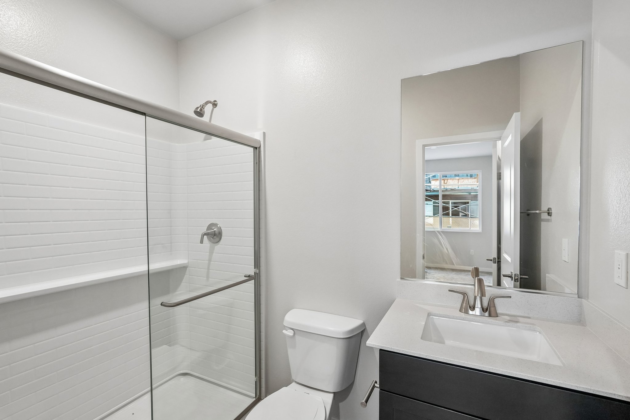 A bathroom with a glass shower.