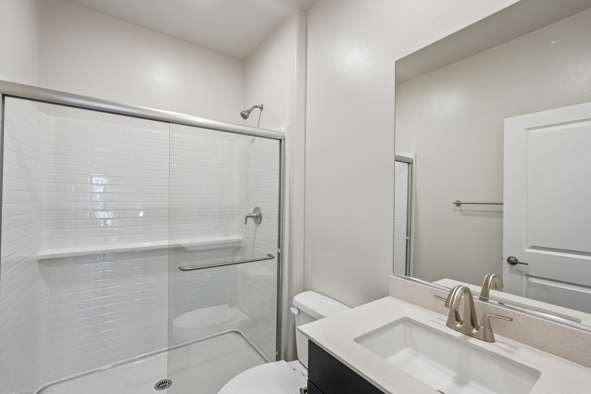 A bathroom with a glass shower.