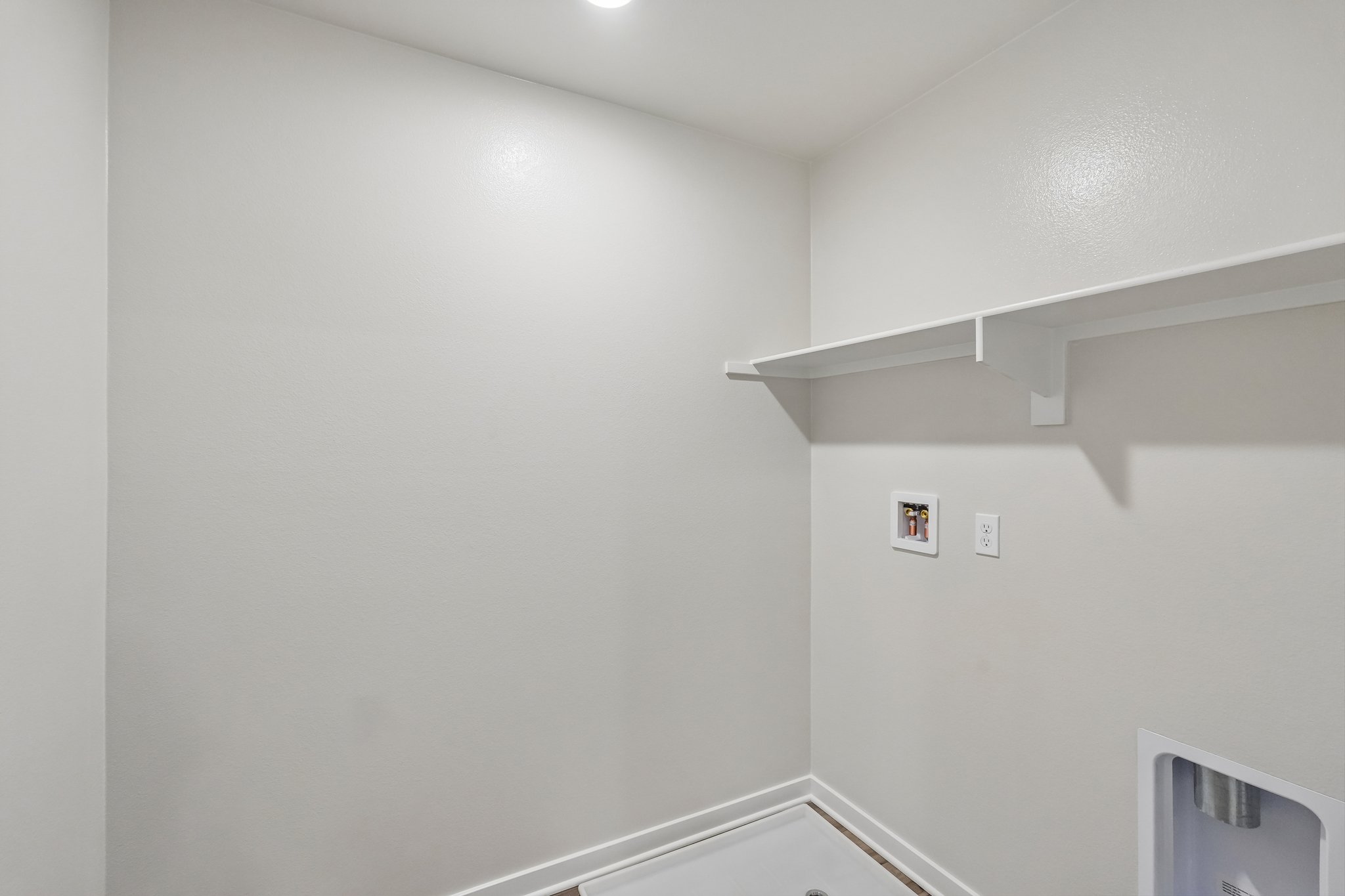 A white wall with a picture on it.