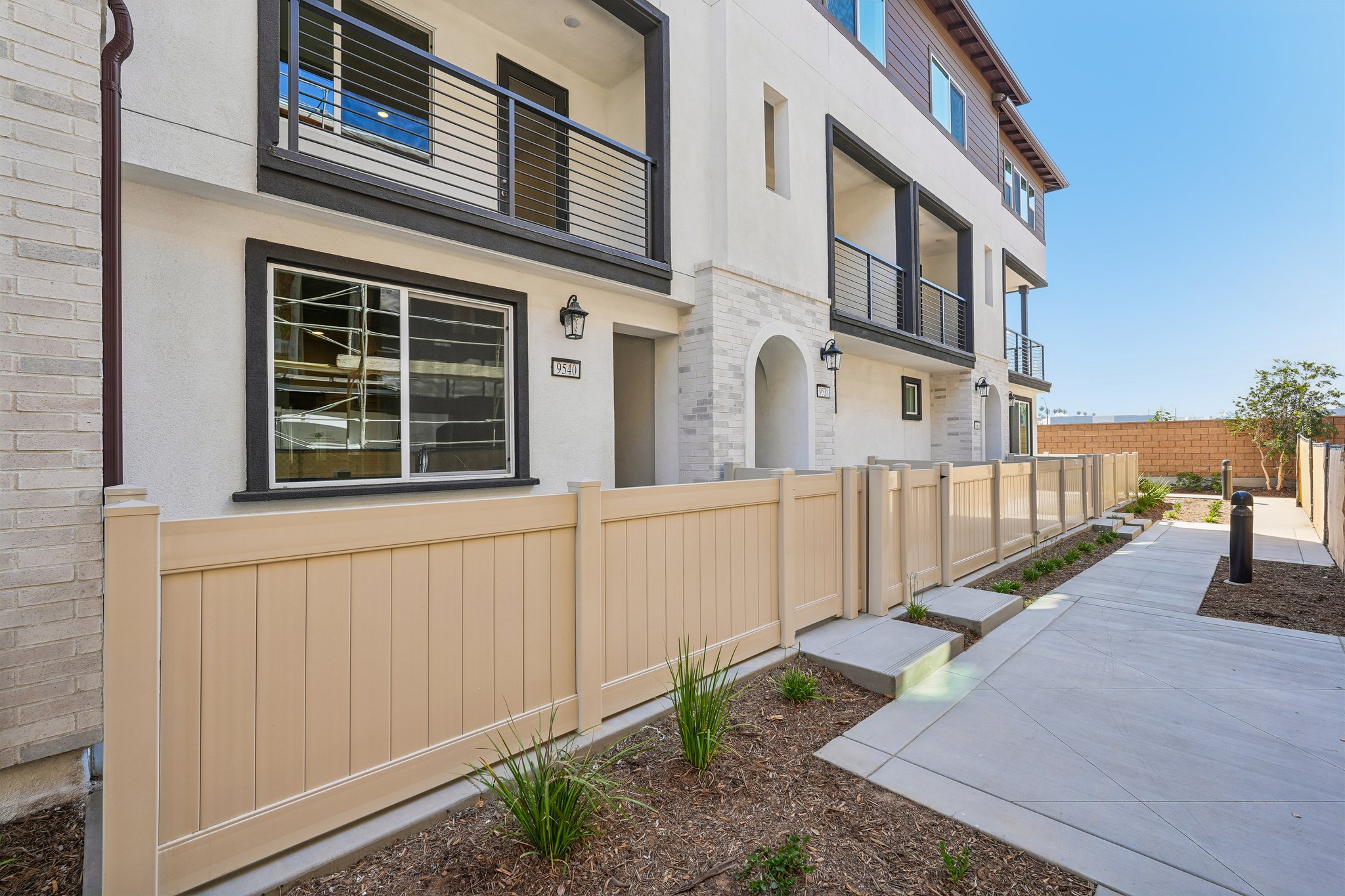 A building with a fence and a walkway.