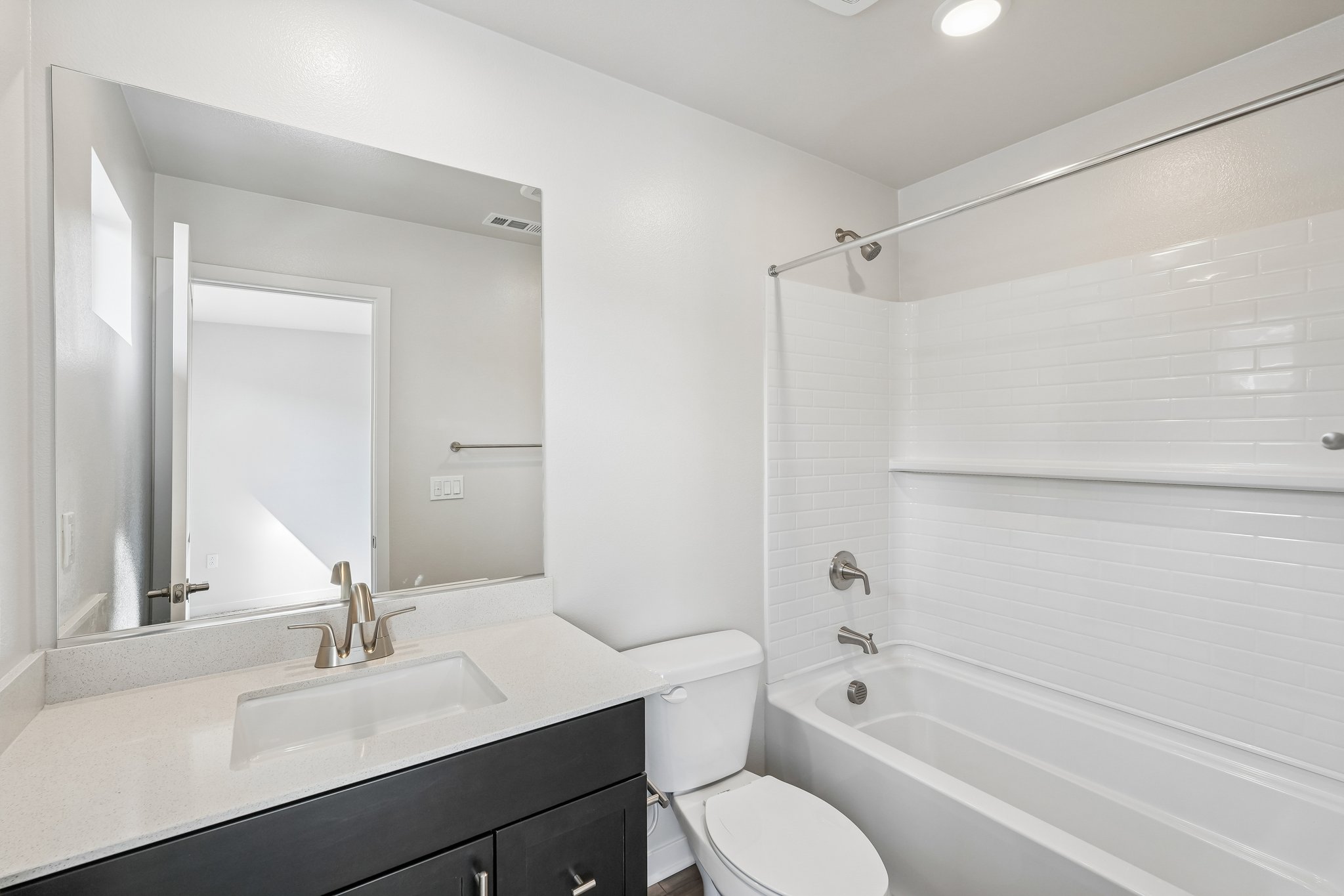 A bathroom with a tub sink and toilet.