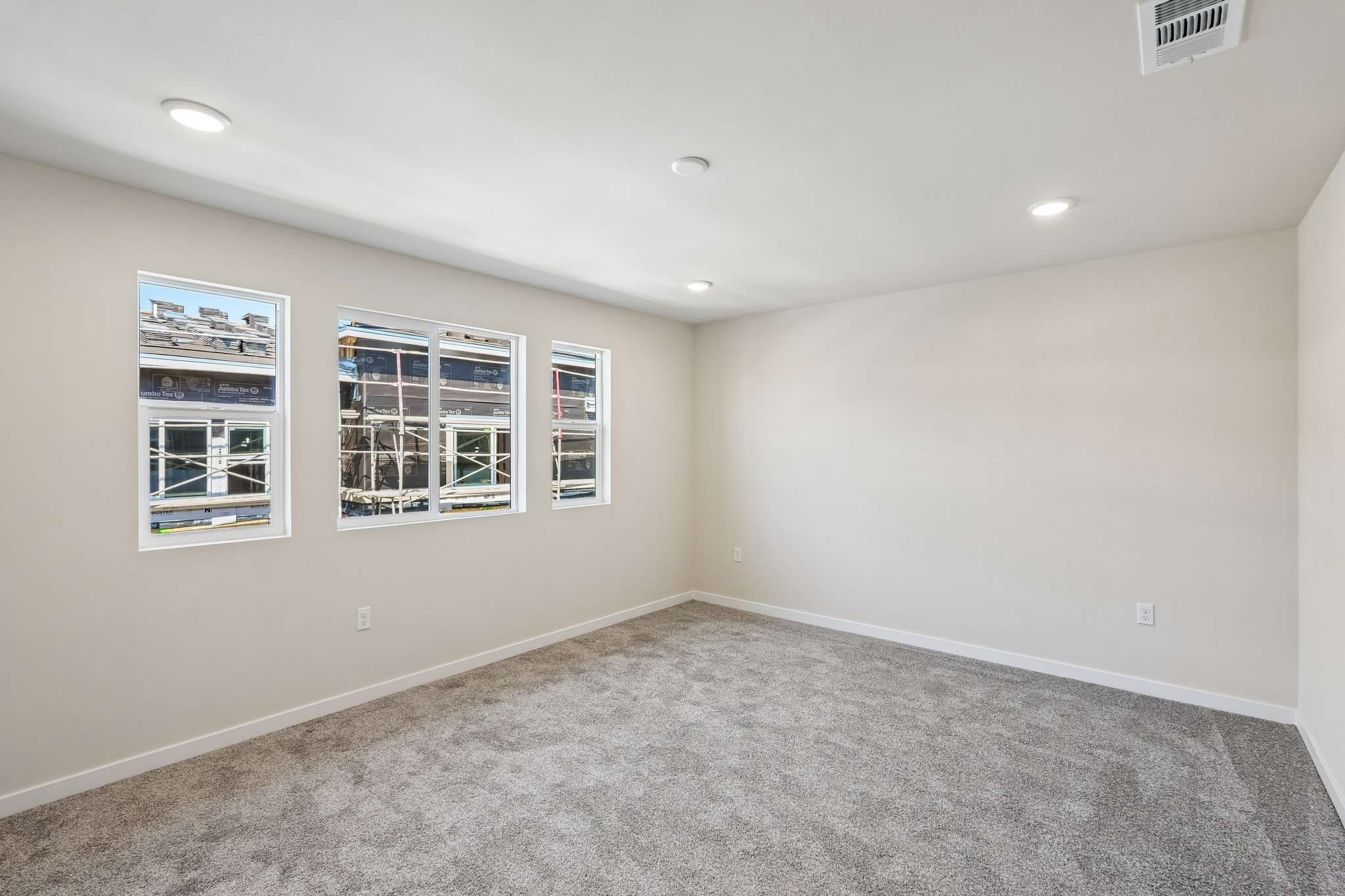 A room with a white wall and a window.