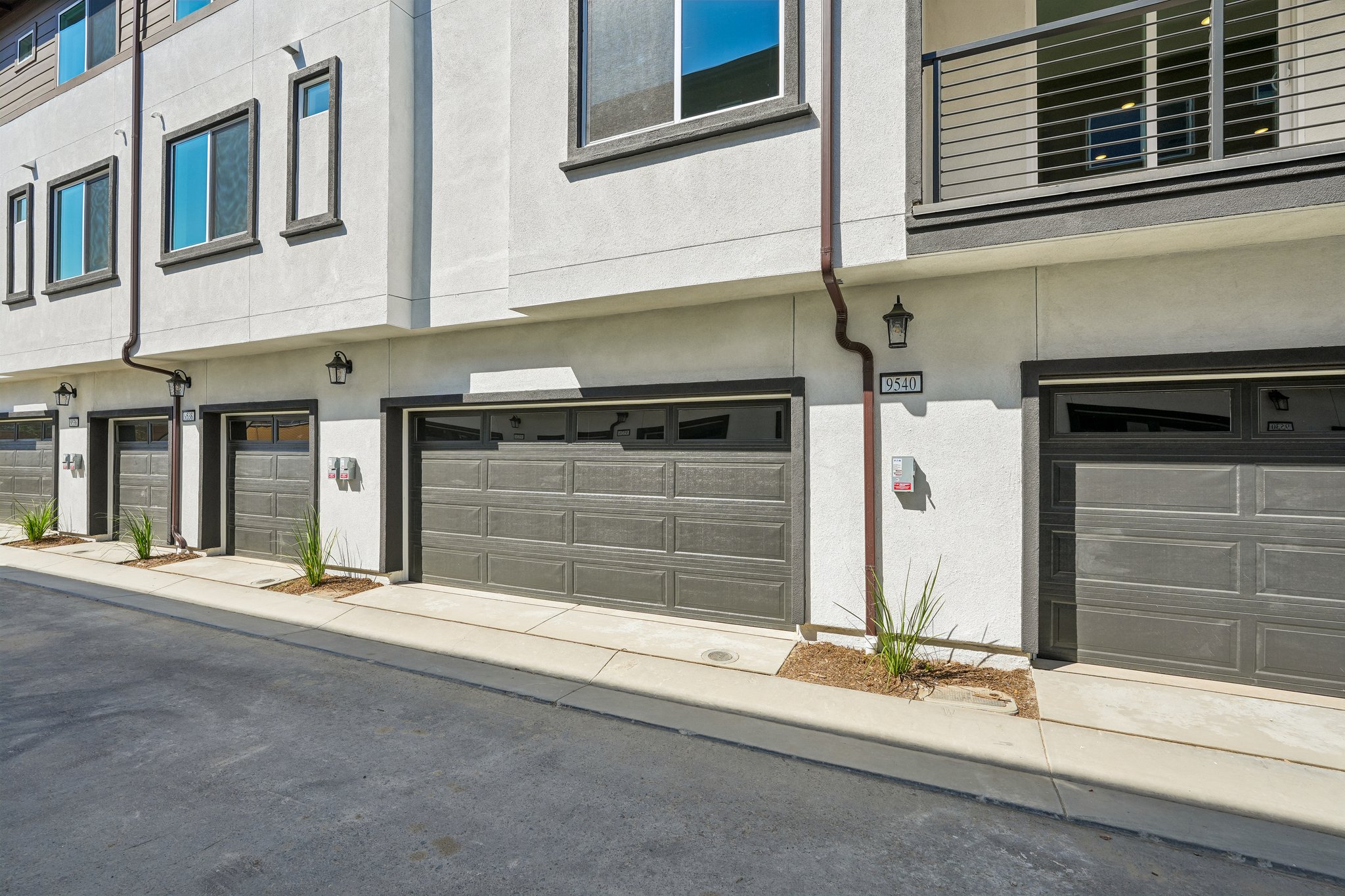 A building with garages and a sidewalk.