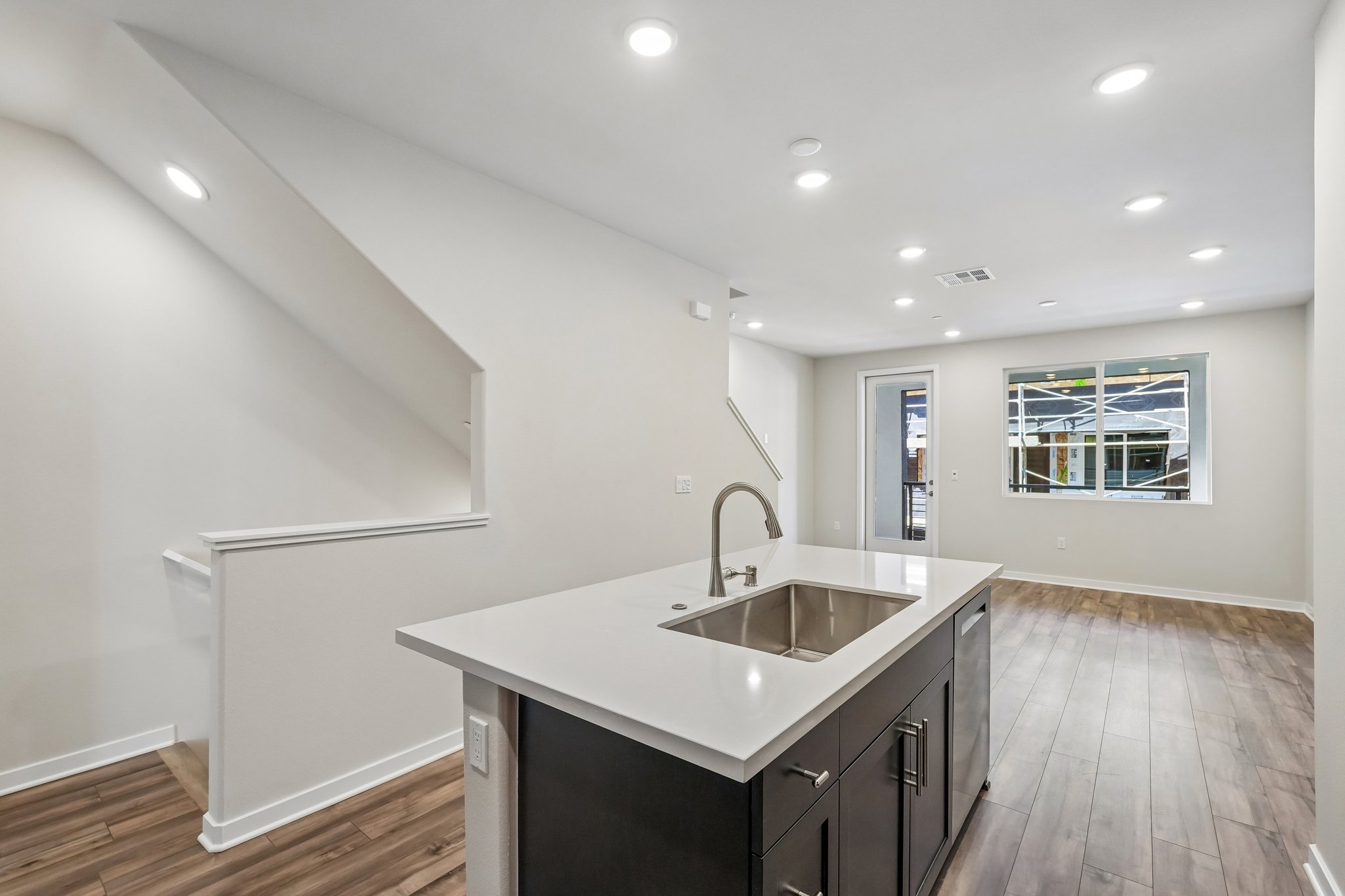 A kitchen with a sink and cabinets.