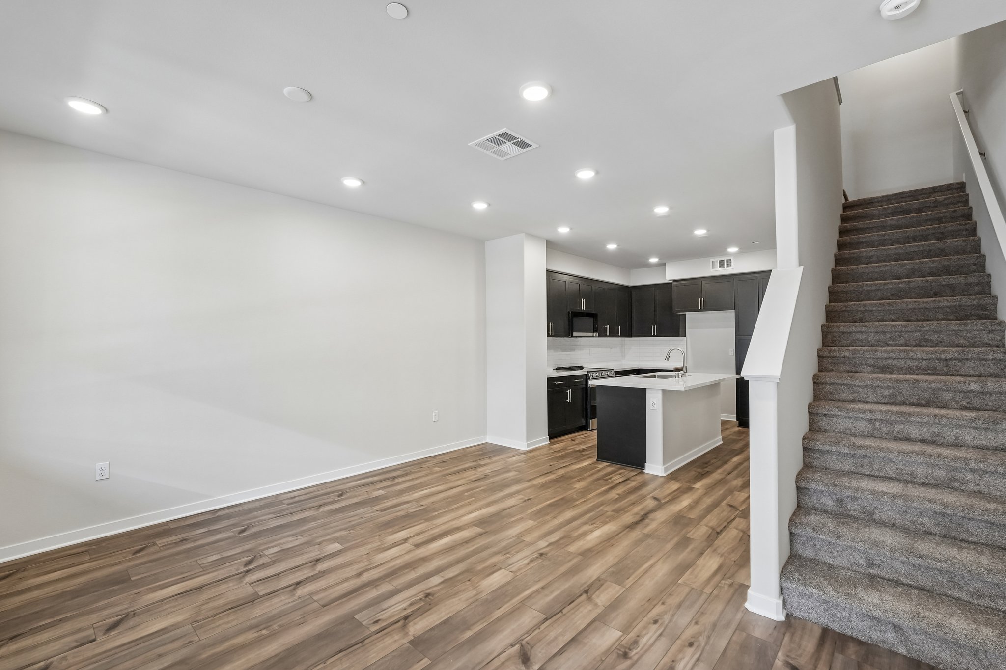A large kitchen with wood floors.