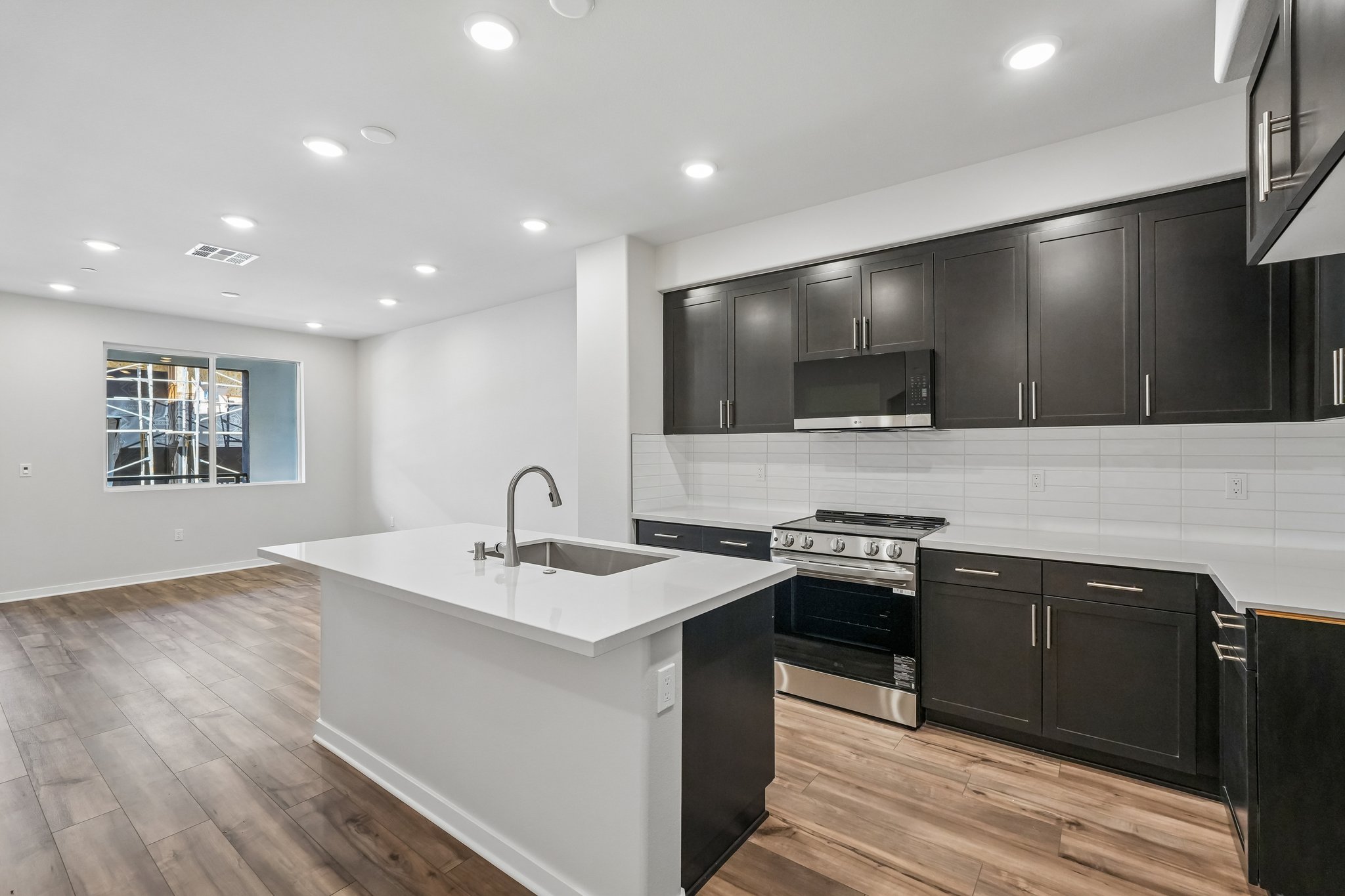 A kitchen with black cabinets.