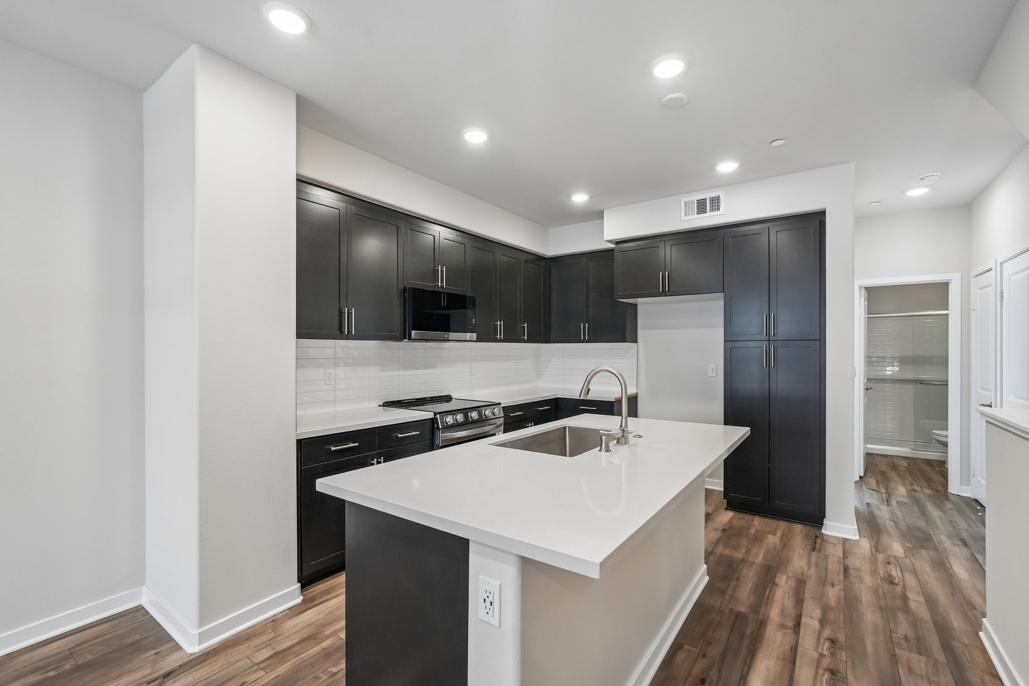 A kitchen with black cabinets.