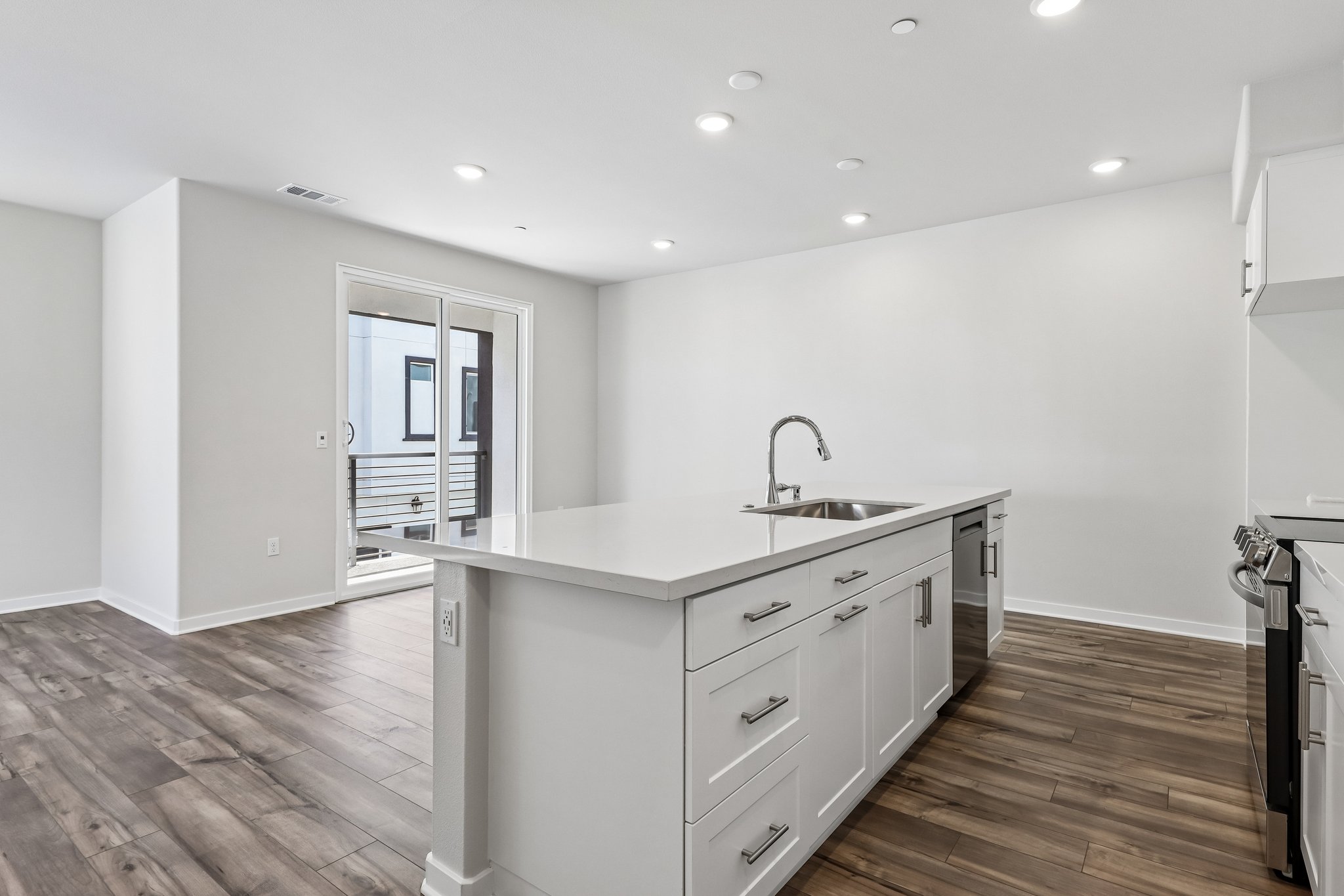A kitchen with white cabinets.