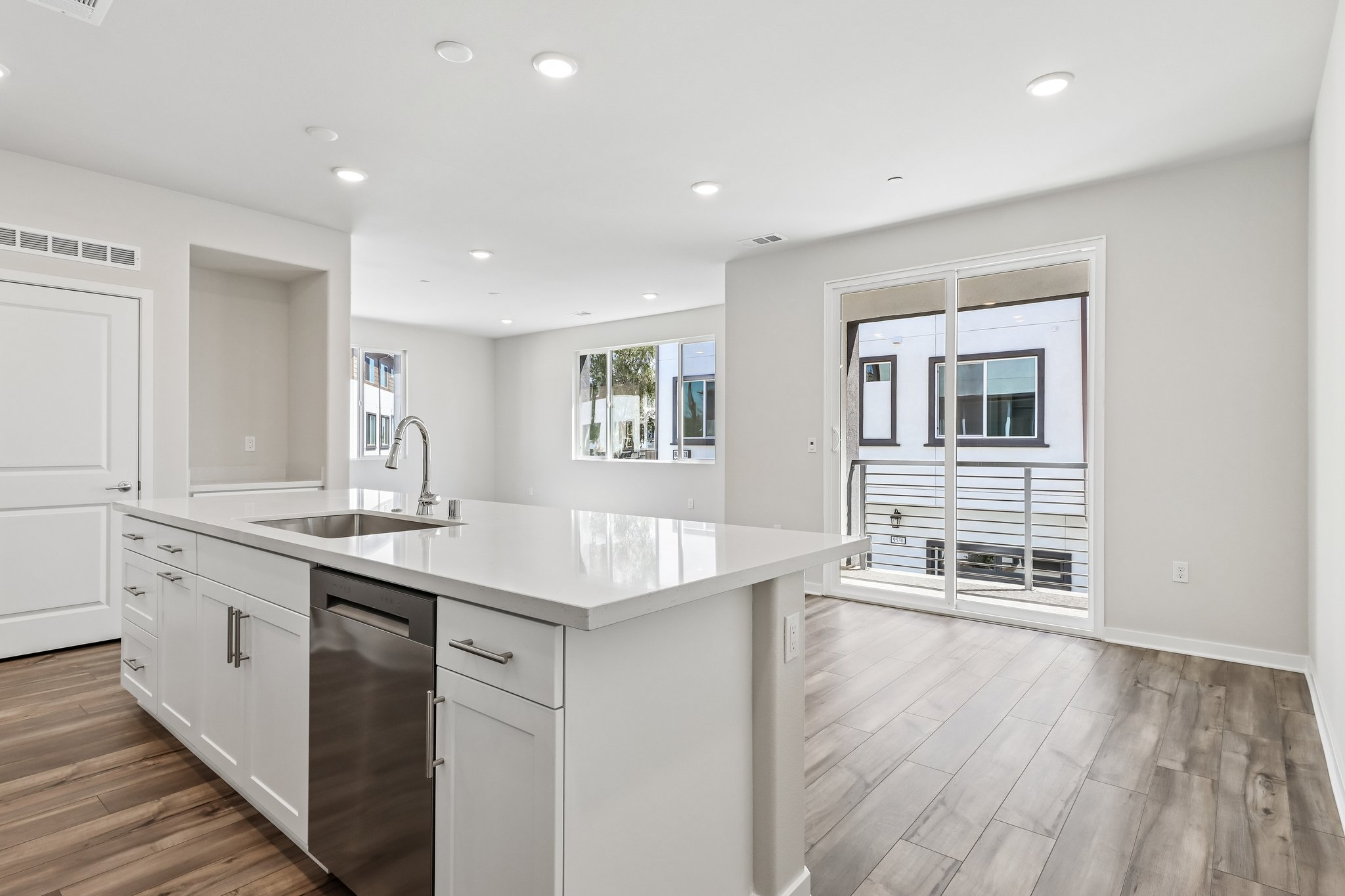 A kitchen with white cabinets.