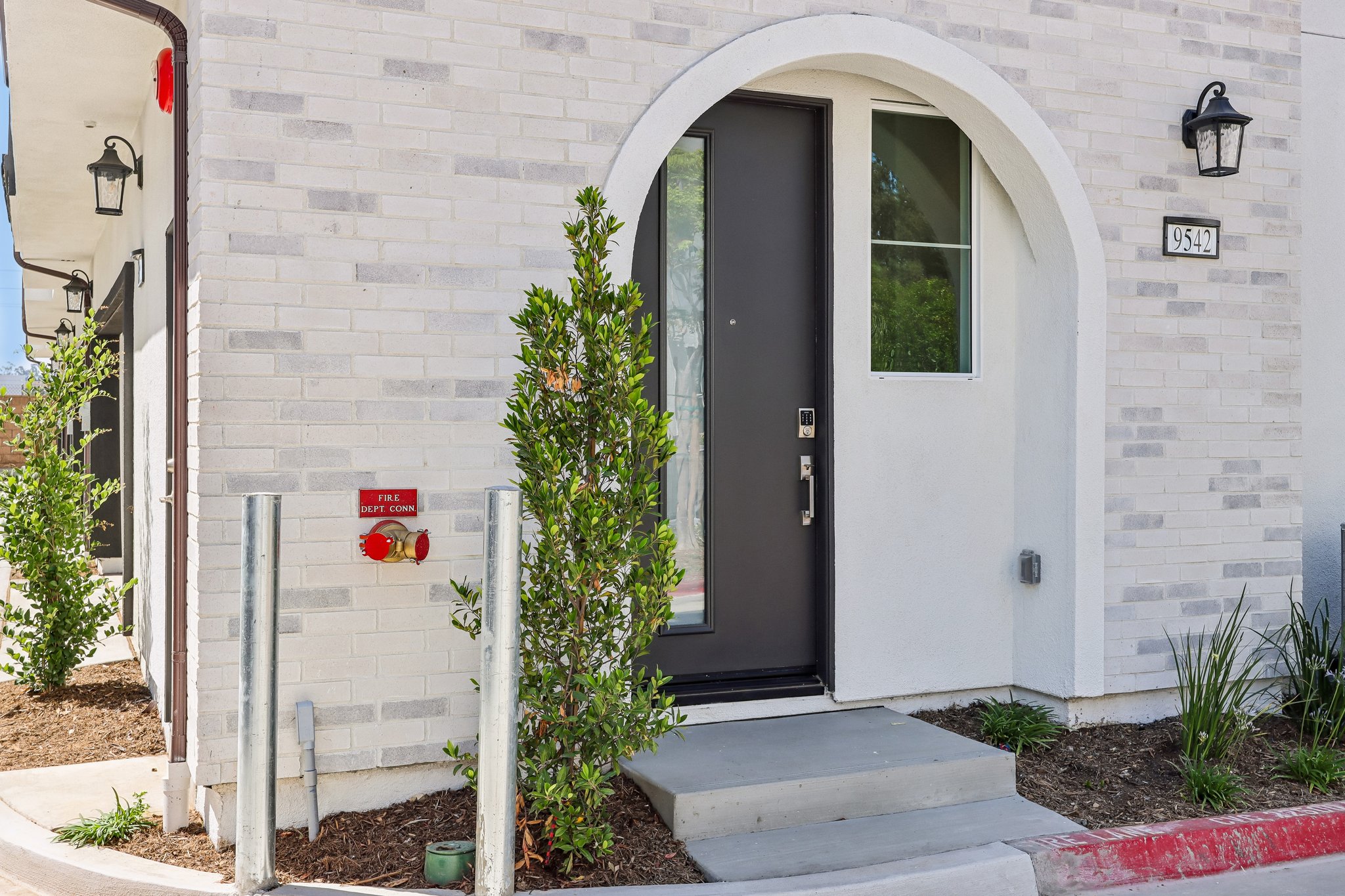 A white building with a black door.