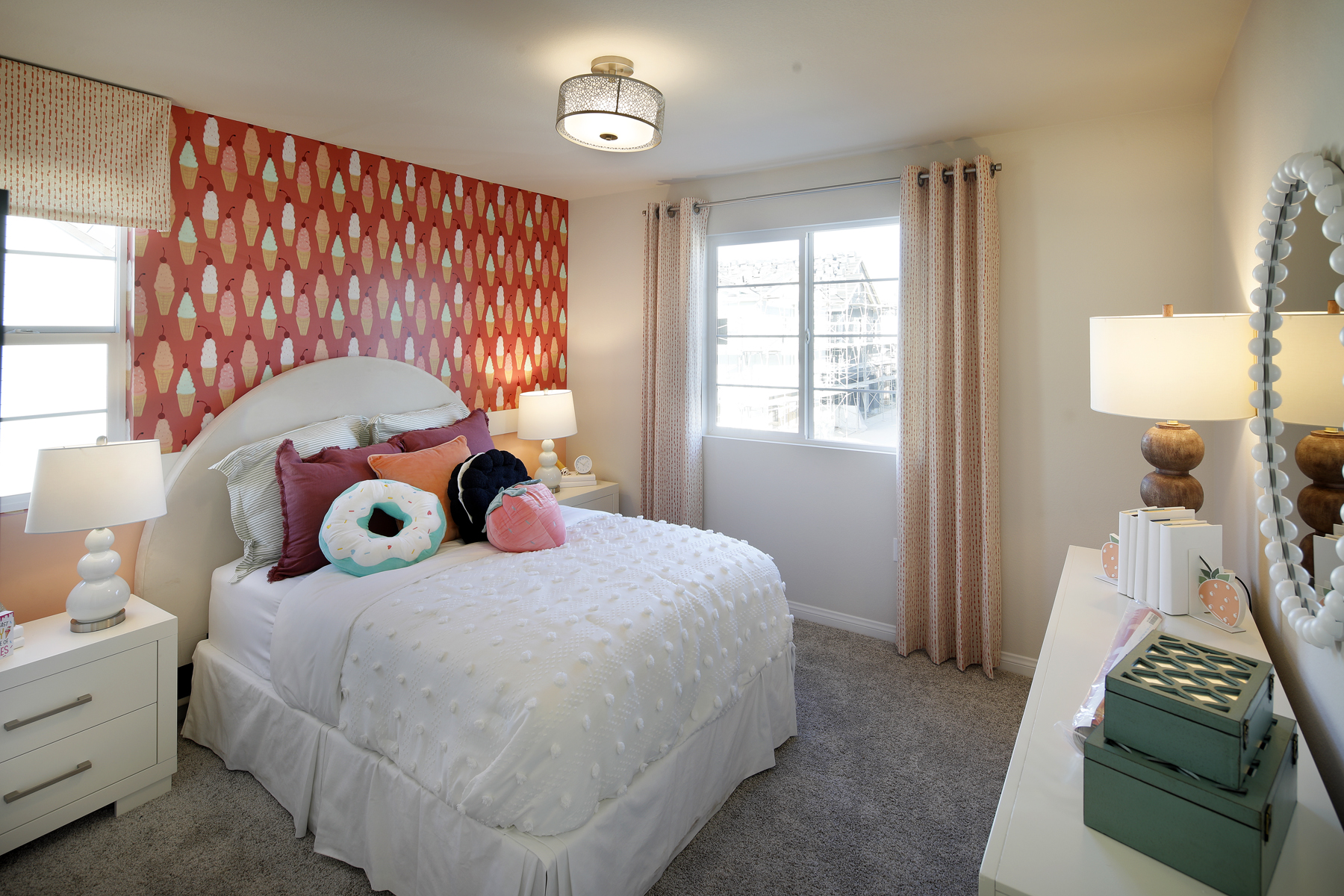 A bedroom with a bed and lamps.