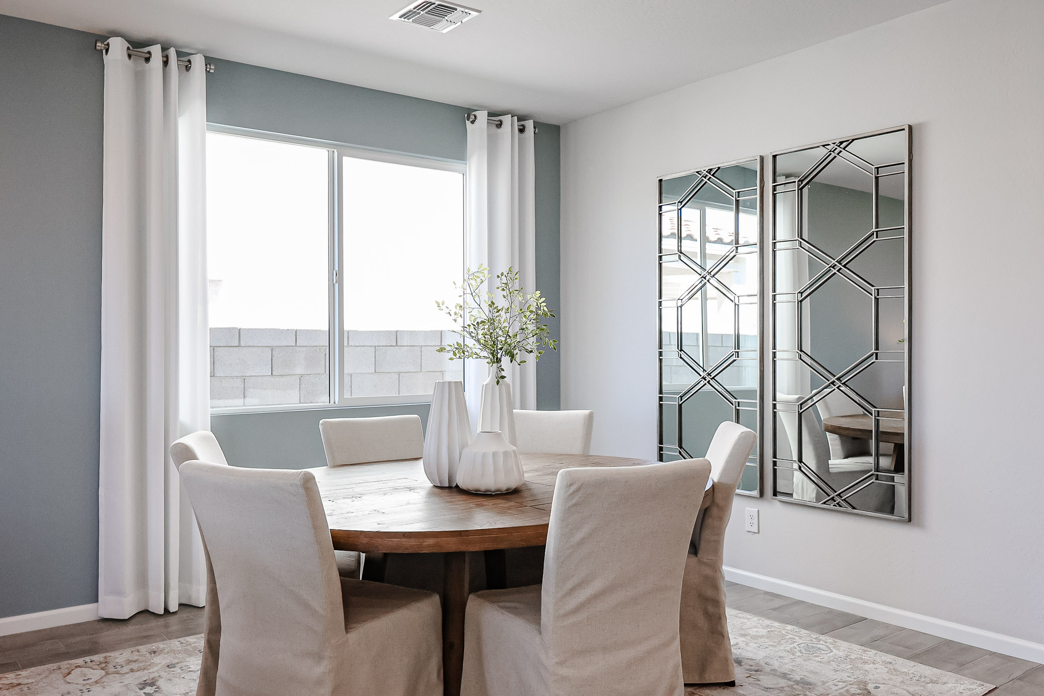 A dining room table with chairs.