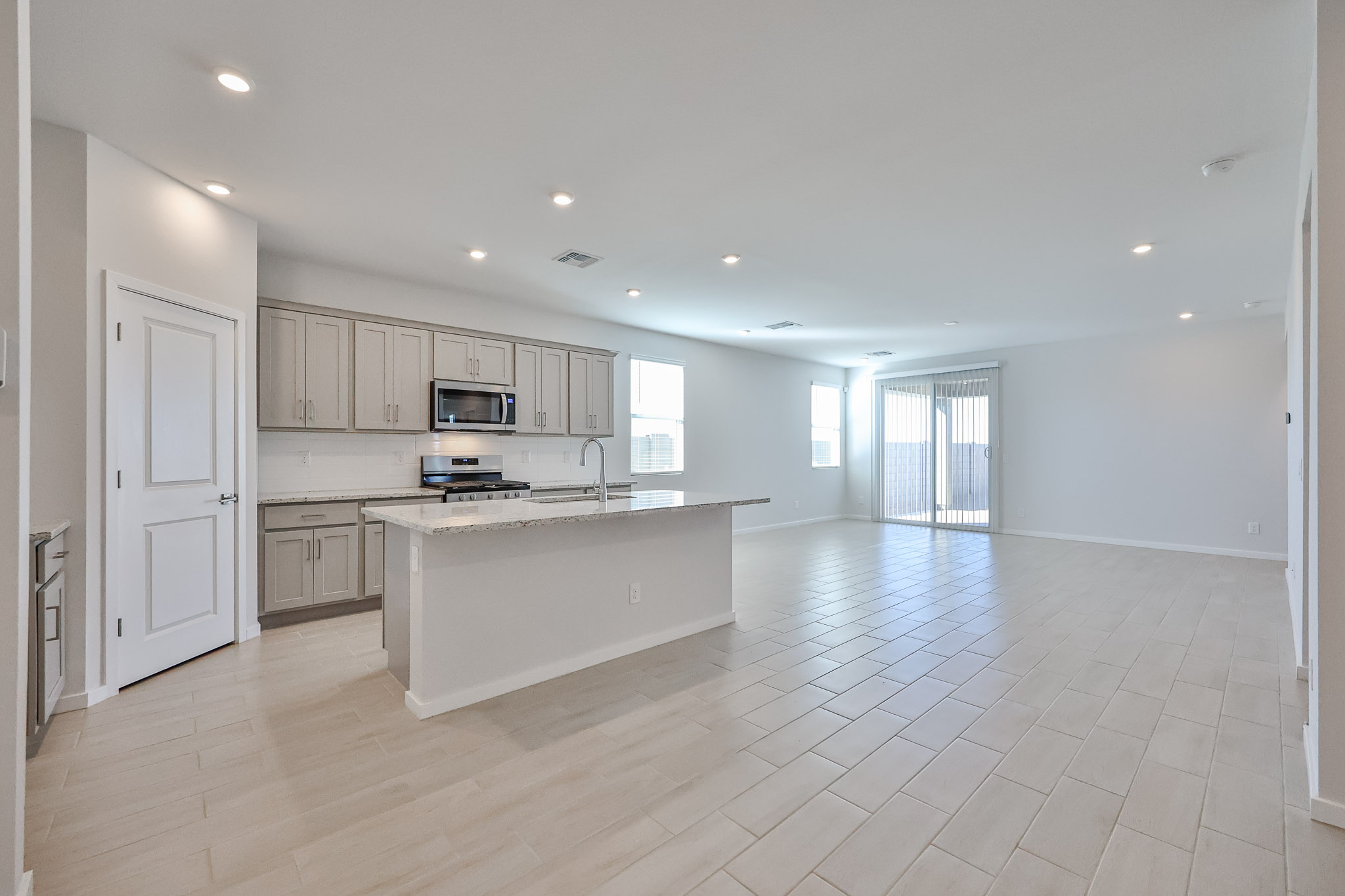 A large kitchen with white cabinets.