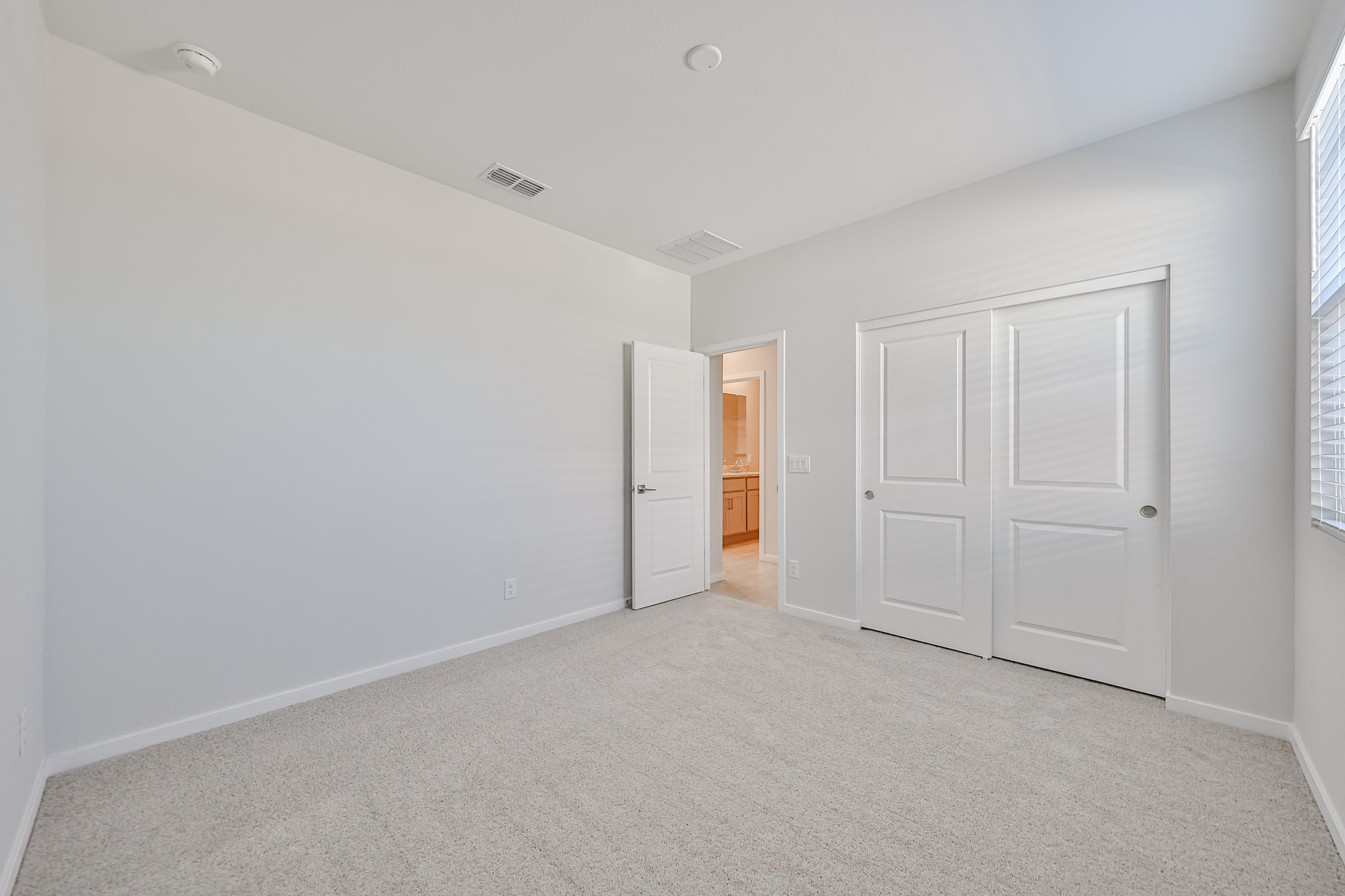 A hallway with white doors.