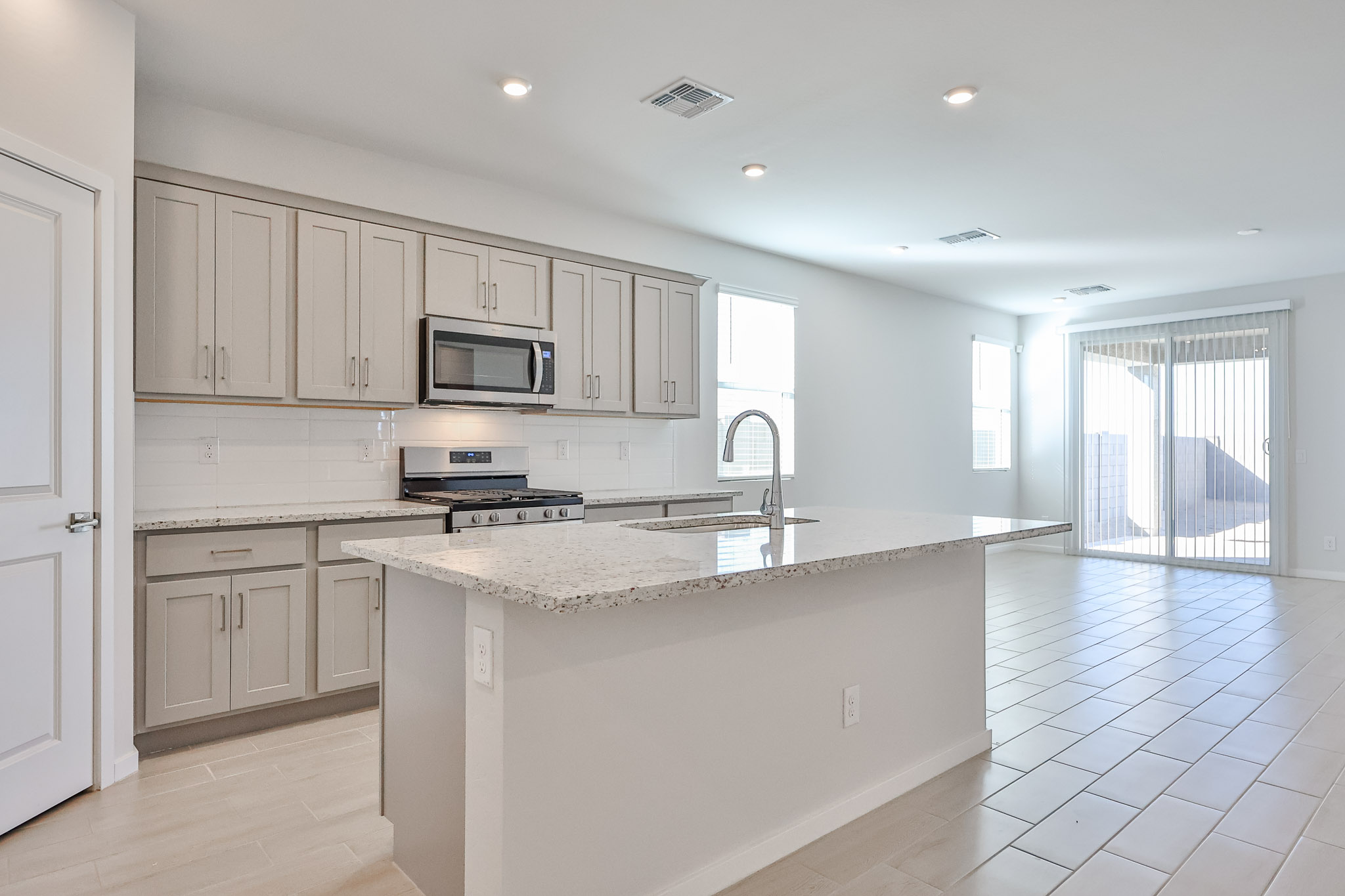 A kitchen with white cabinets.