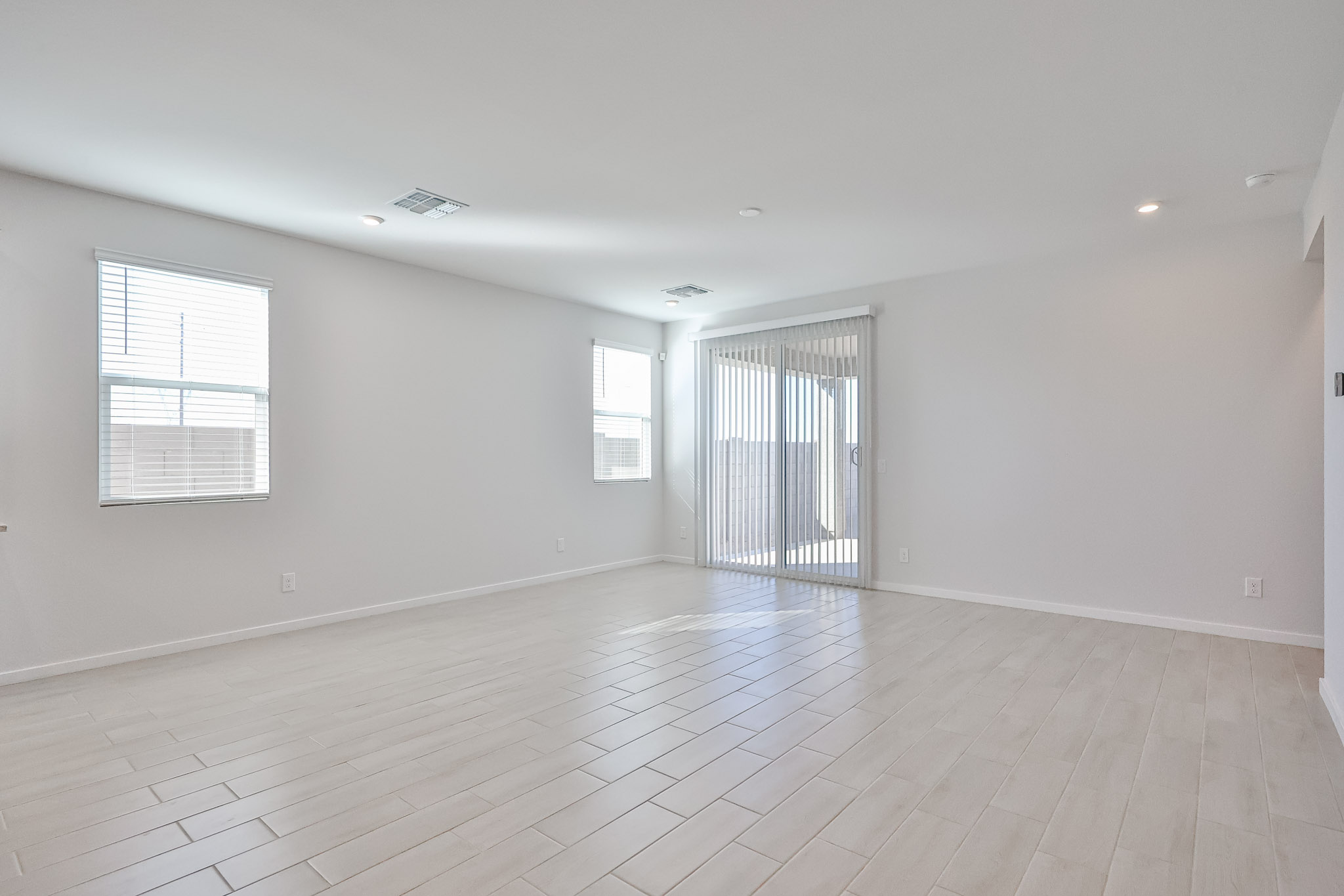 A room with a wood floor and windows.