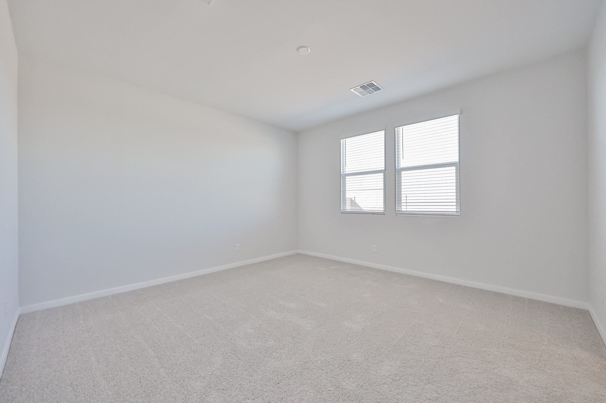 A room with a window and a carpet.