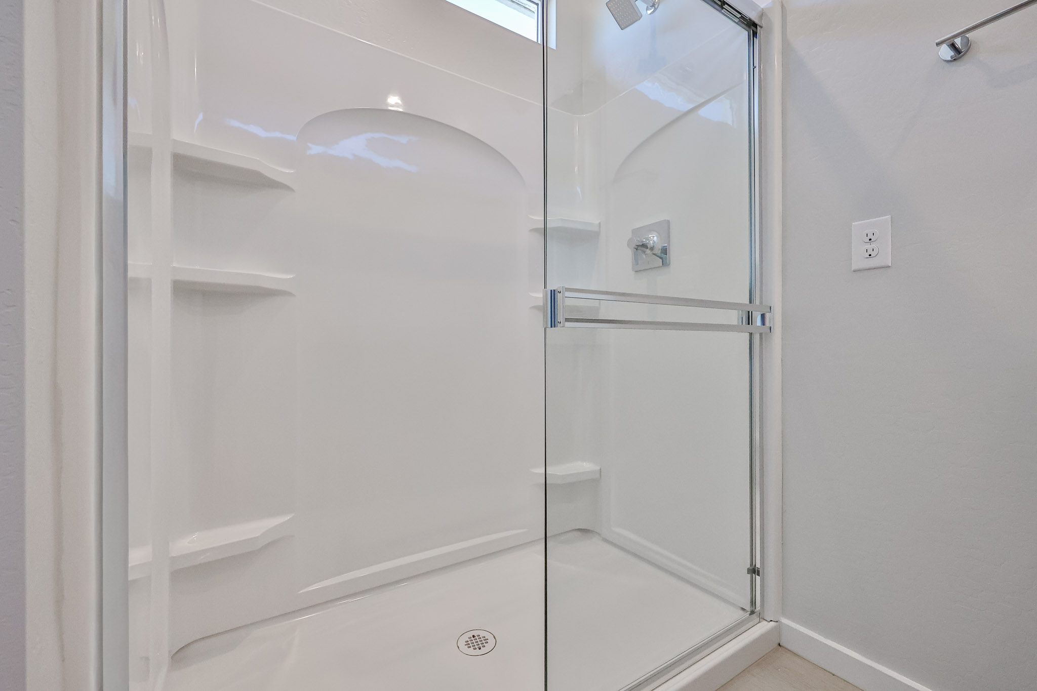 A shower with a glass door.
