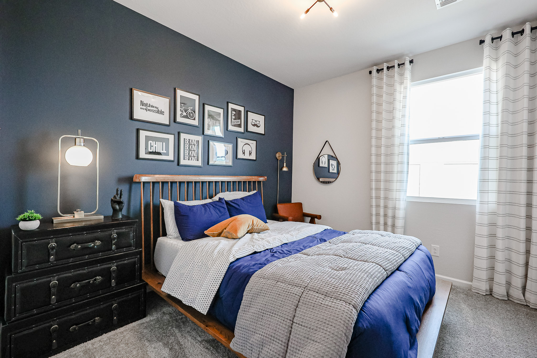 A bedroom with a bed and a dresser.