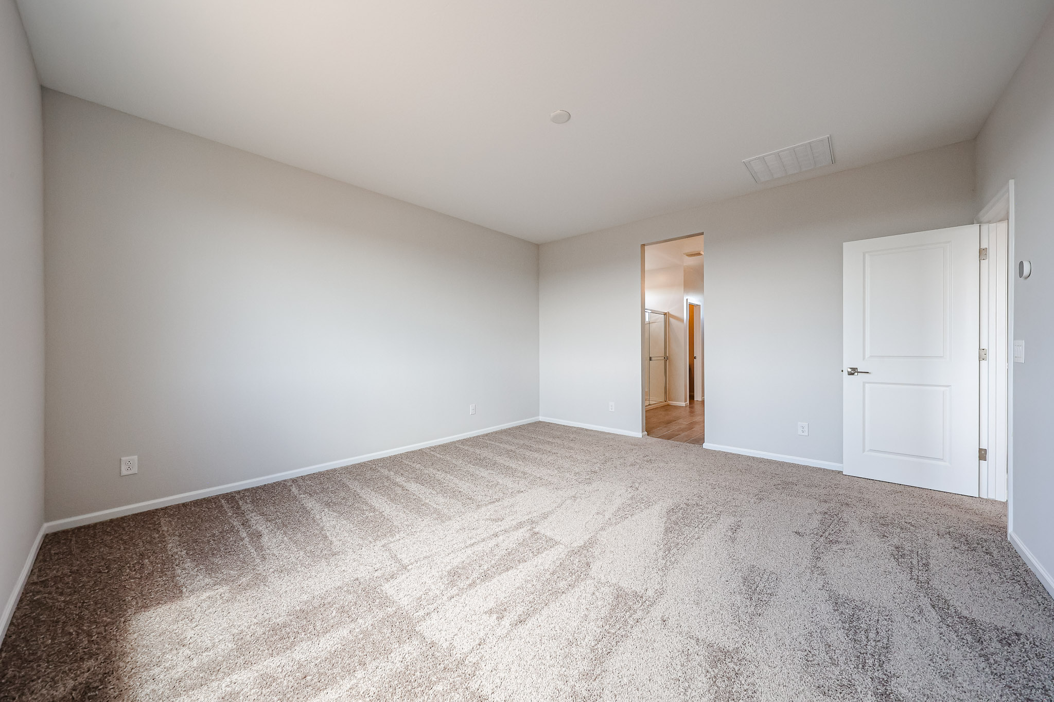 A hallway with white doors.