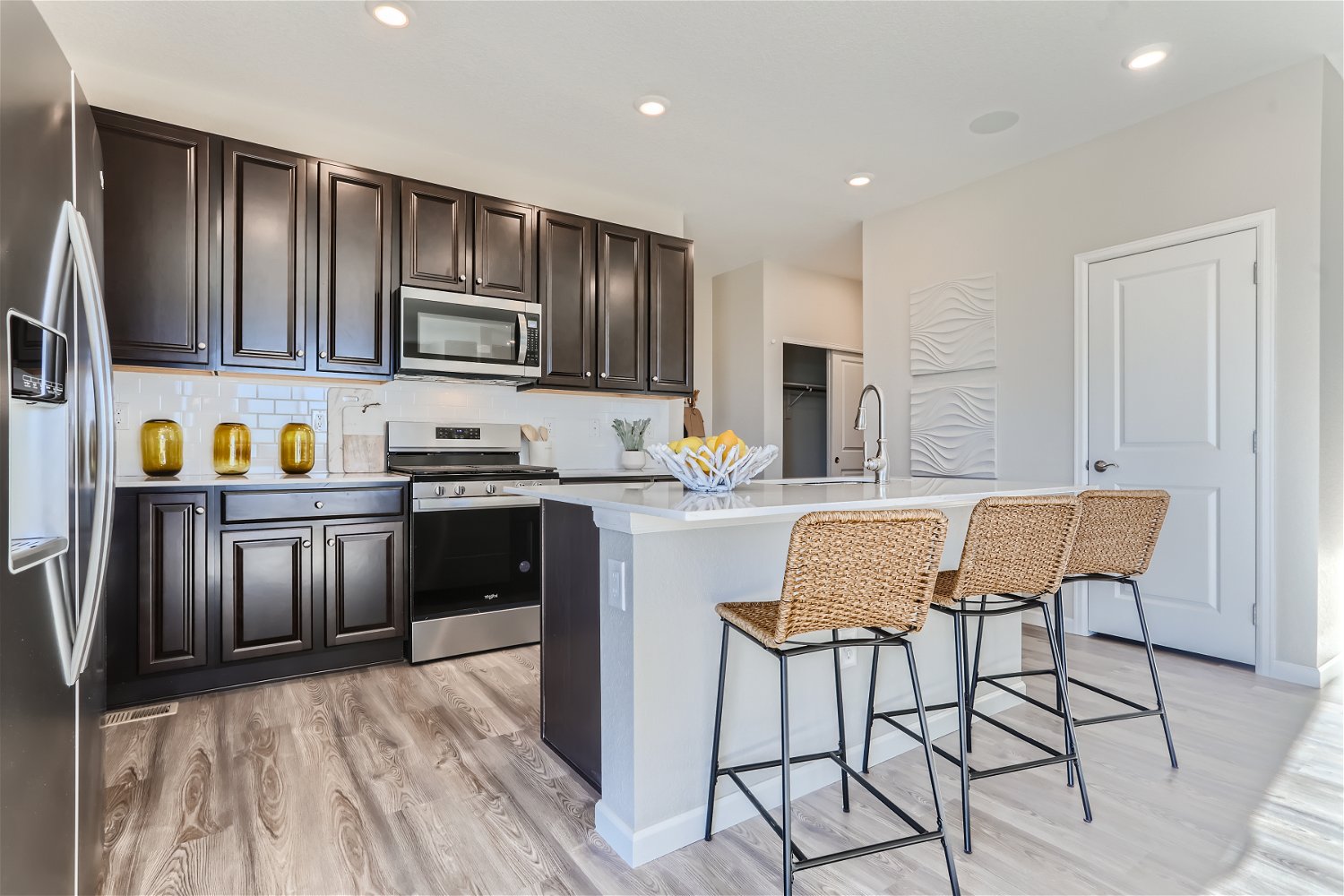 A kitchen with black cabinets.